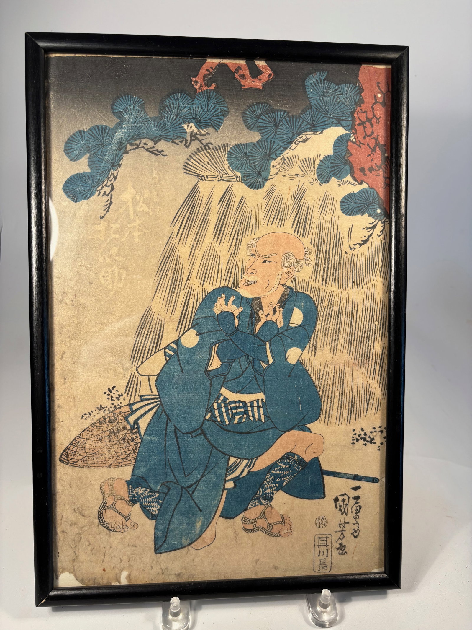 Utagawa Kuniyoshi (1798–1861), Kabuki Actor Portrait, Woodblock Print: Circa. 1840s, Japanese woodblock print depicting a kabuki actor in dynamic pose beneath a pine tree and waterfall, possibly from a famous drama or historical play. Signed “Ichiy?sai Kuniyoshi
