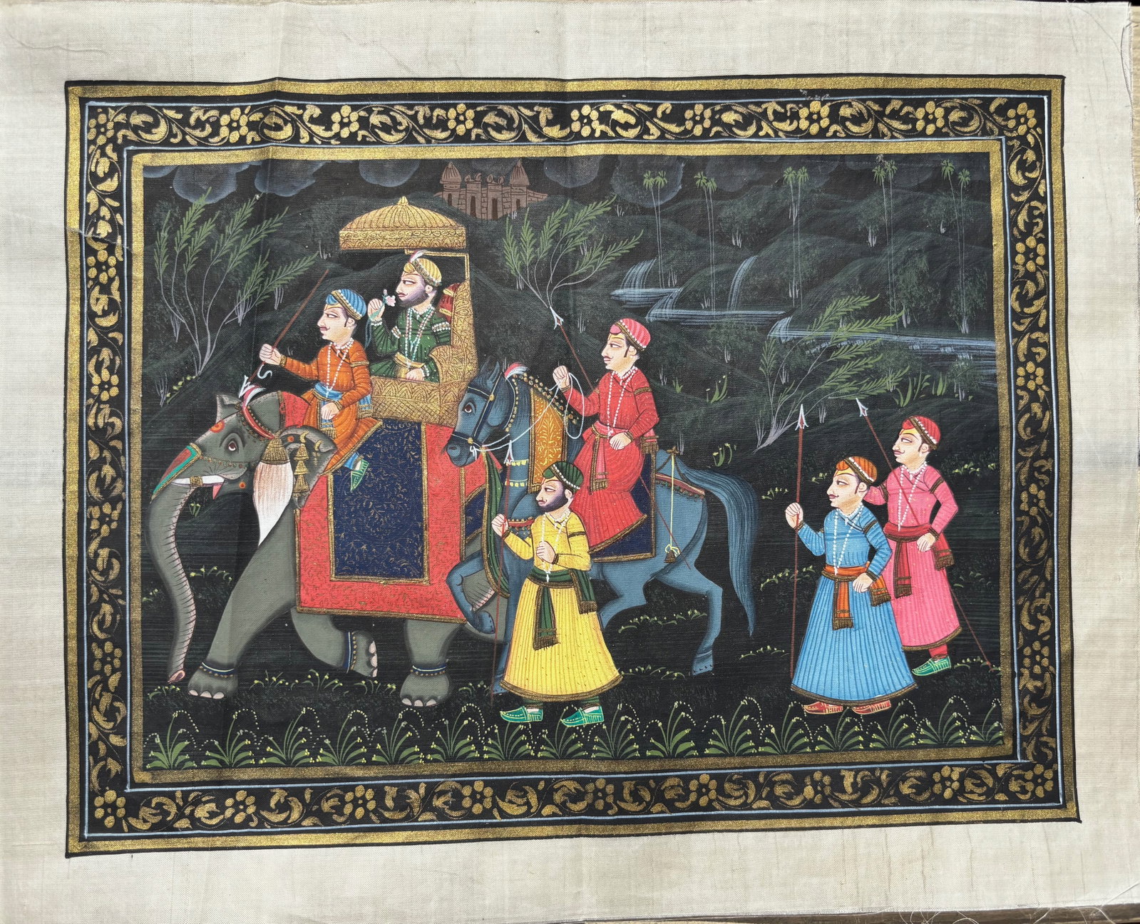 A Hand-Painted Indian Miniature on Silk – Royal Procession, Mughal Style: 19th century ; A finely hand-painted Indian miniature painting on silk, depicting a royal procession in the Mughal style. The central figure is shown seated on a richly adorned elephant beneath a cere