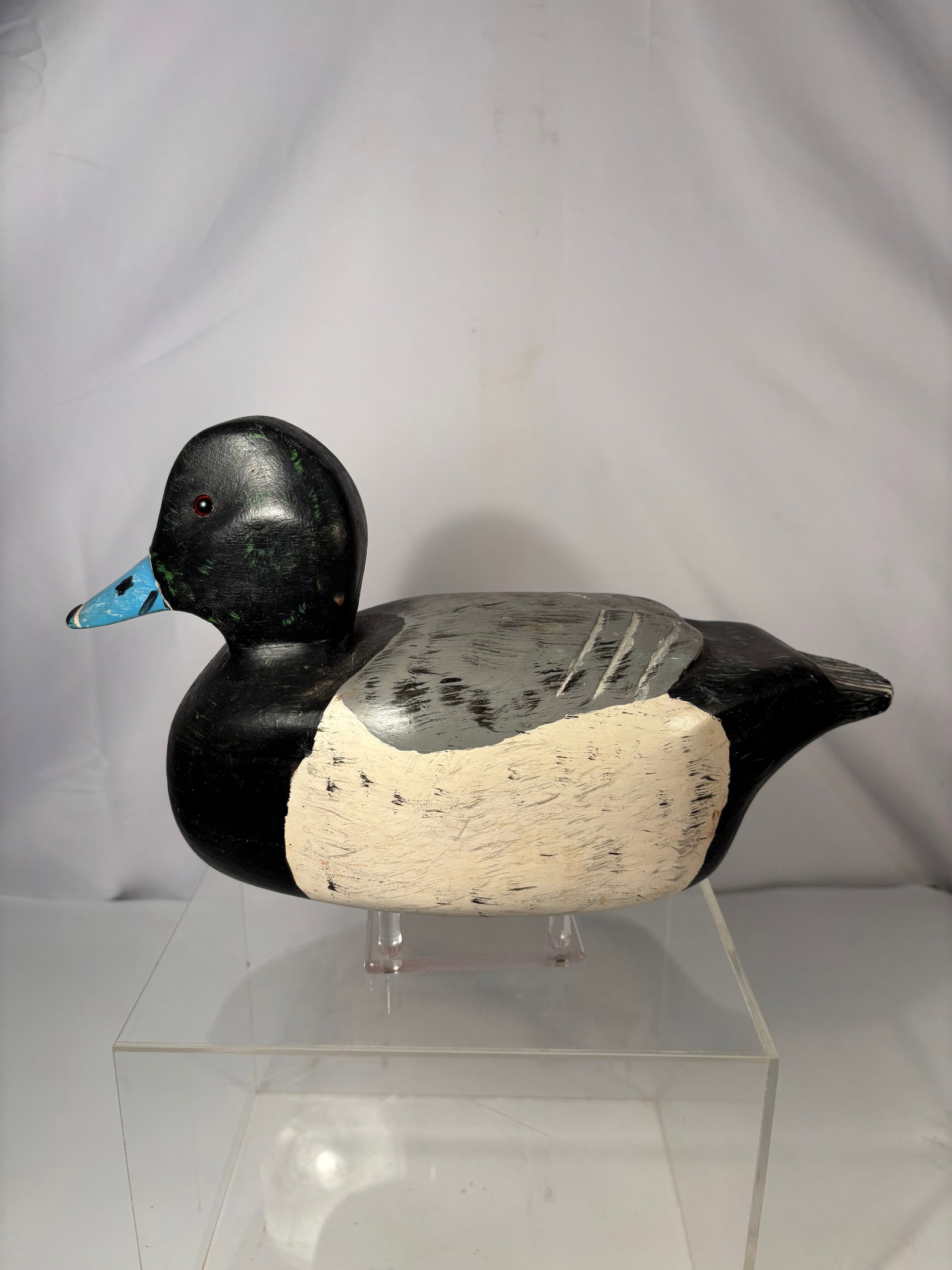 A Vintage Hand-Carved Scaup (Bluebill) Drake Duck Decoy, Attributed to Bud: Hand-carved wooden duck decoy depicting a Scaup (Bluebill) drake, attributed to Bud, made in the American working-decoy tradition, mid-20th century. with carved wing separation lines and original blac