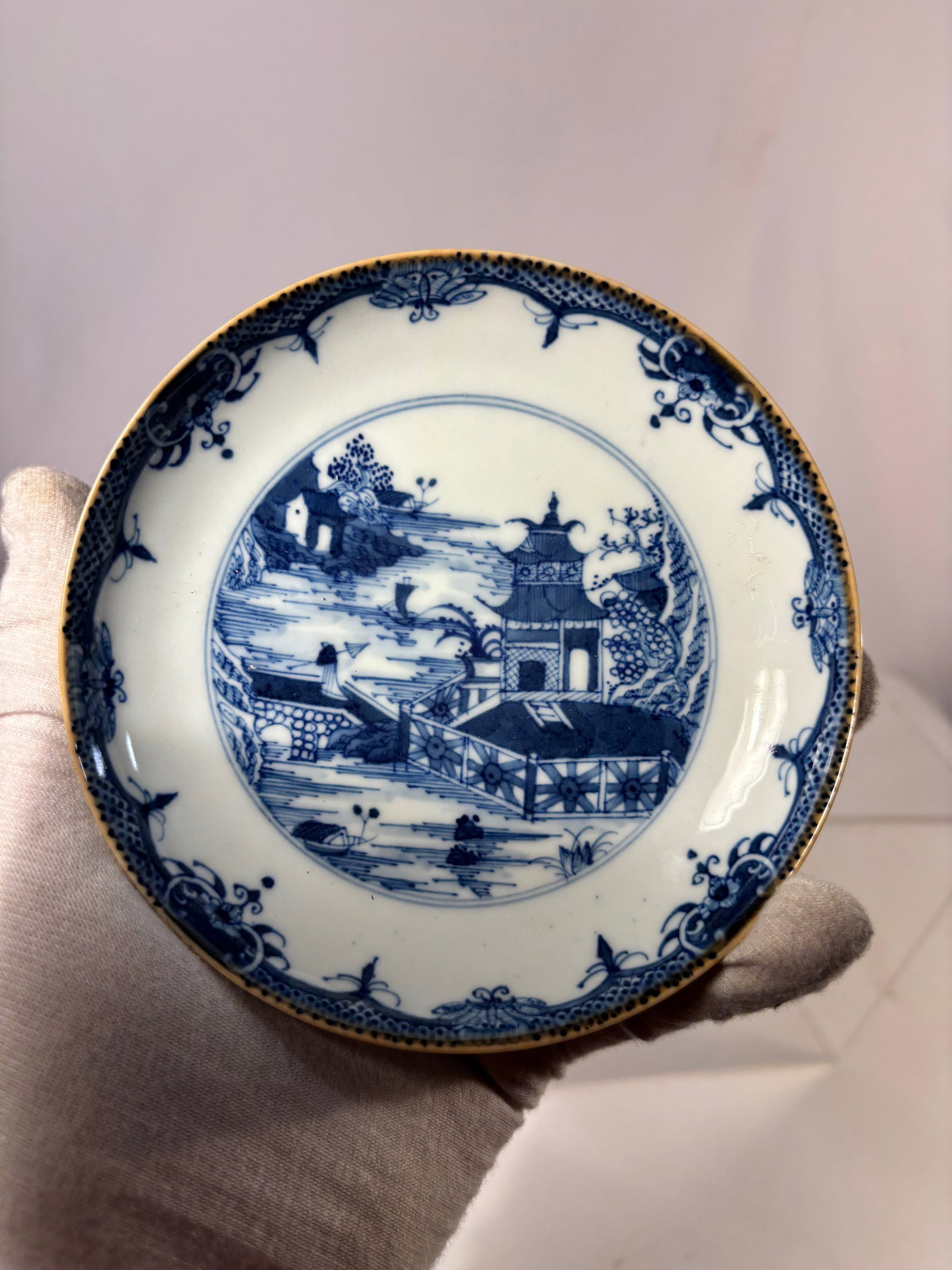 A Chinese Blue and White Porcelain Dish, “Qianlong Nian Zhi?? Mark and of the Period: Qianlong period (1736–1795) ; A finely potted Chinese blue and white porcelain dish, Qianlong period (1736–1795), decorated in underglaze cobalt blue with a riverside landscape scene depicting pav
