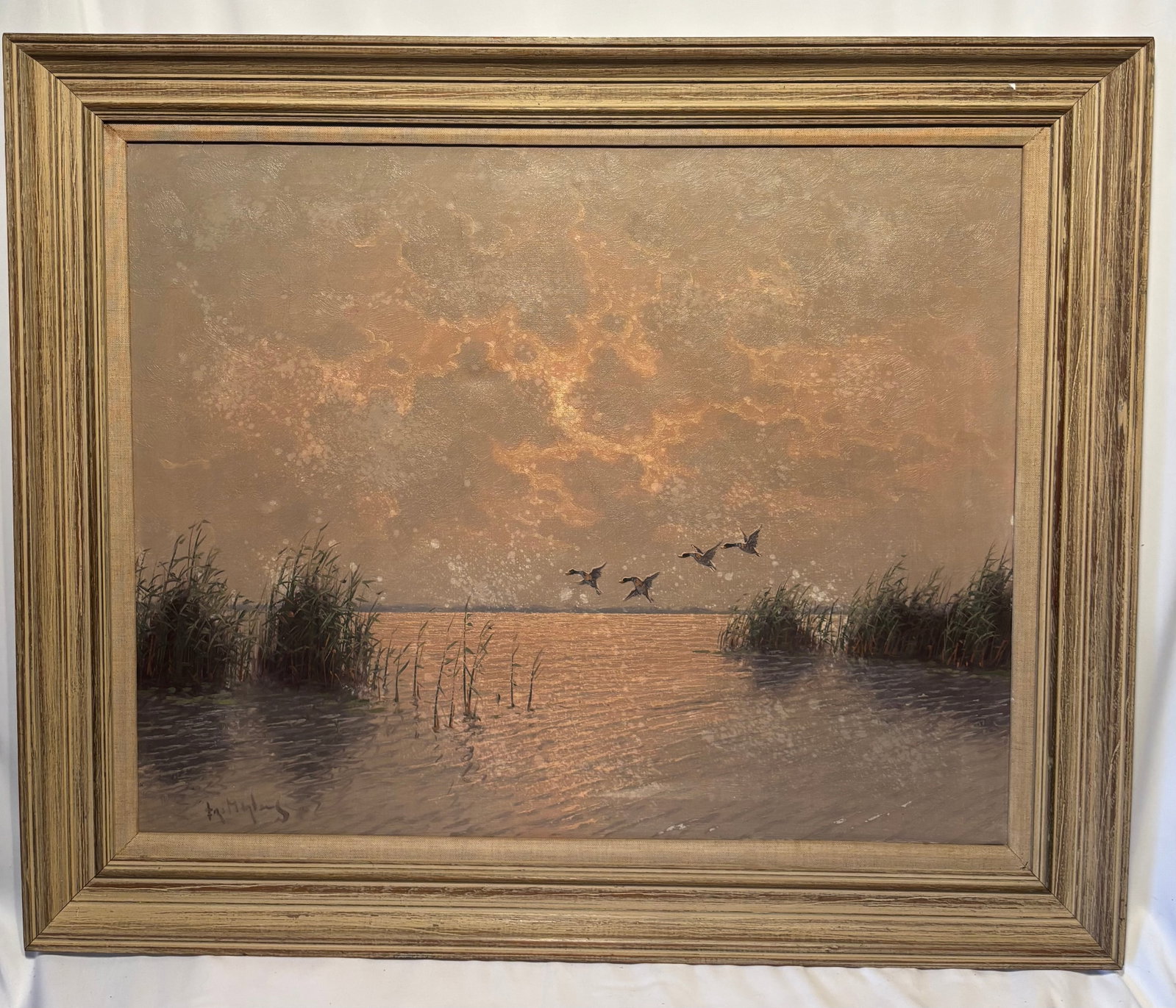 Fritz Martens (1880–1955) Ducks Over Marsh at Sunset, Oil on Canvas: Fritz Martens (Dutch-American, 1880–1955), oil on canvas depicting a tranquil marsh landscape at sunset. The composition features calm reflective waters bordered by reeds and grasses, with a flock o