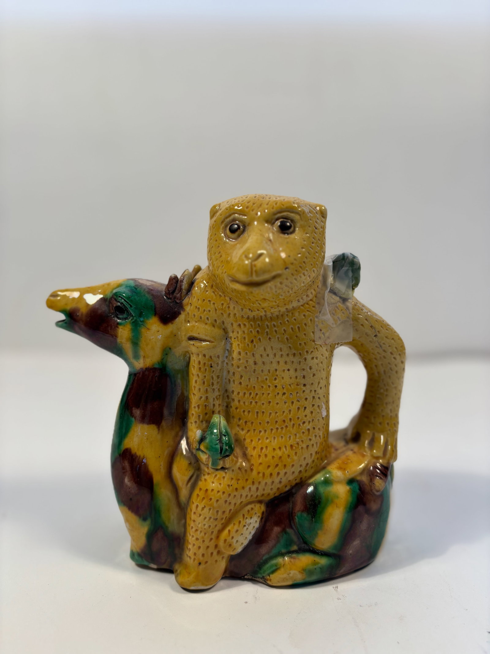 A Chinese Sancai-Glazed Monkey porcelain teapot: Qing dynasty (1644-1912); Dimensions?Height: 7 inches .