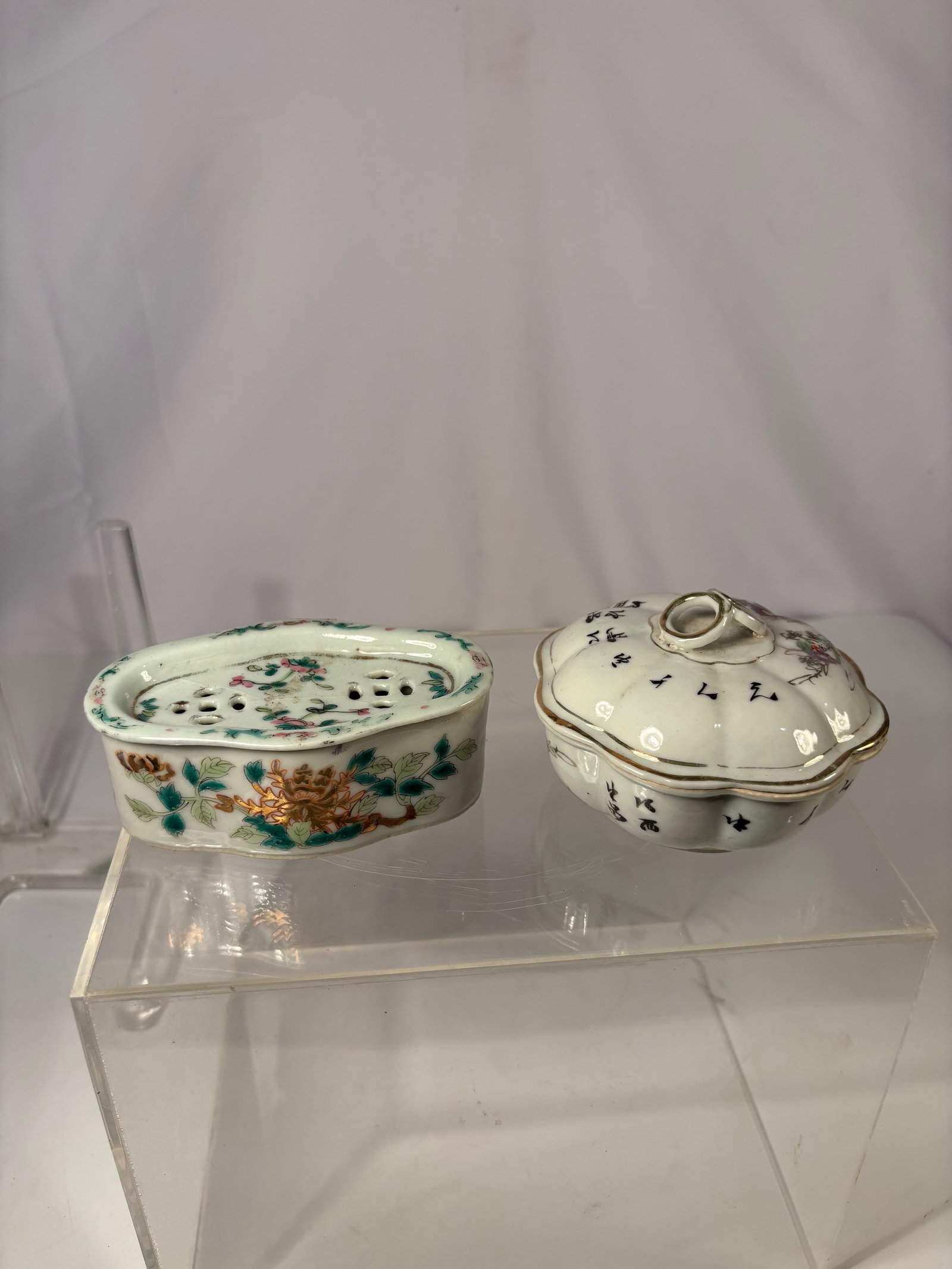 A Group of Two Chinese famille rose Porcelain pieces: Qing dynasty(1644-1912) ; Comprising a famille rose oval reticulated dish, decorated with vibrant peony blooms and leafy scrolls along the sides, the top fitted with a pierced insert painted with