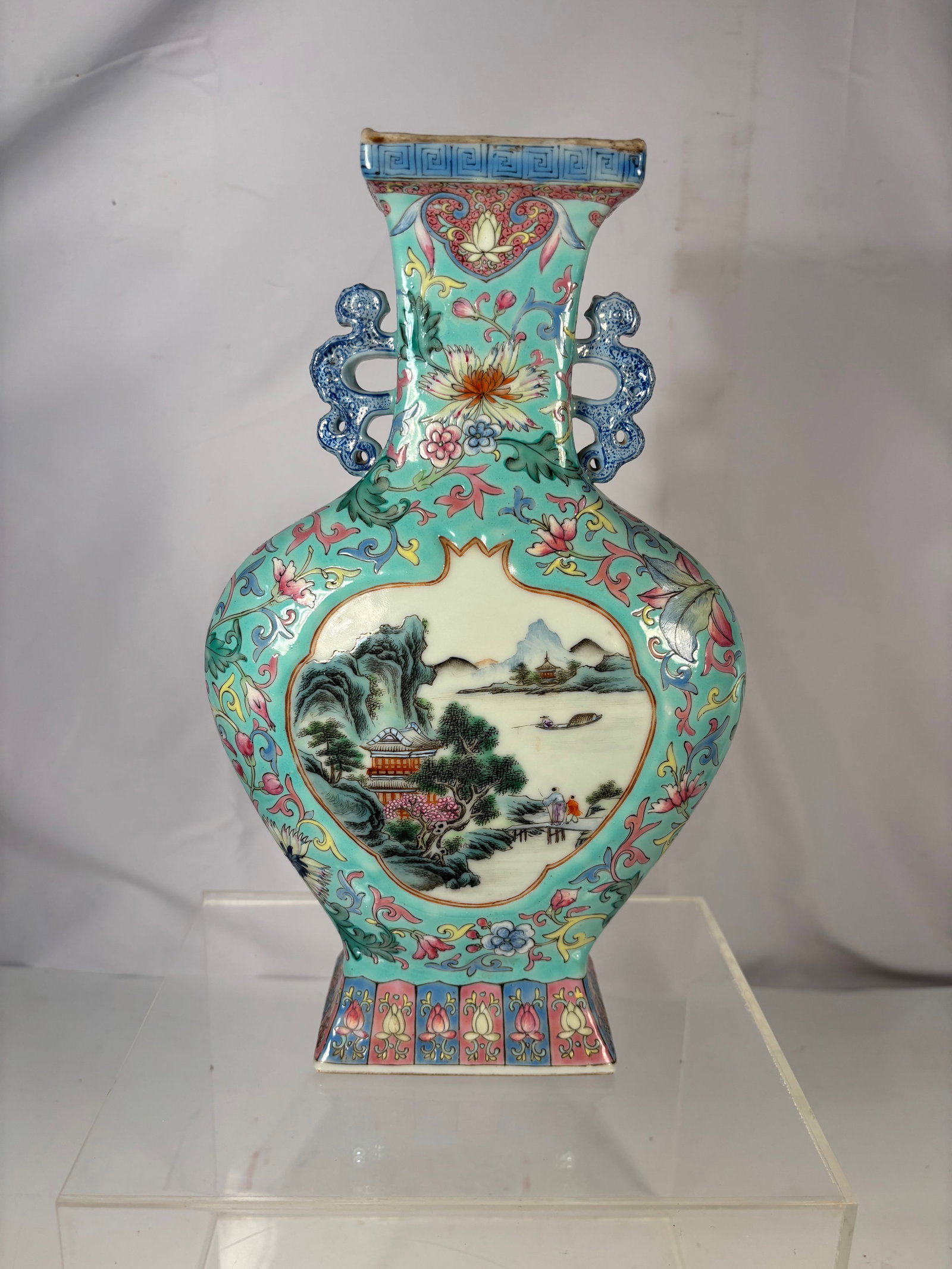 A Chinese Turquoise Ground Famille Rose Porcelain Vase: Qing Dynasty(1644-1912) ;Chinese porcelain vase decorated with famille rose floral motifs on a turquoise ground. Square mouth with recessed interior and unglazed footrim. Height: 11 inches; Length: 7 
