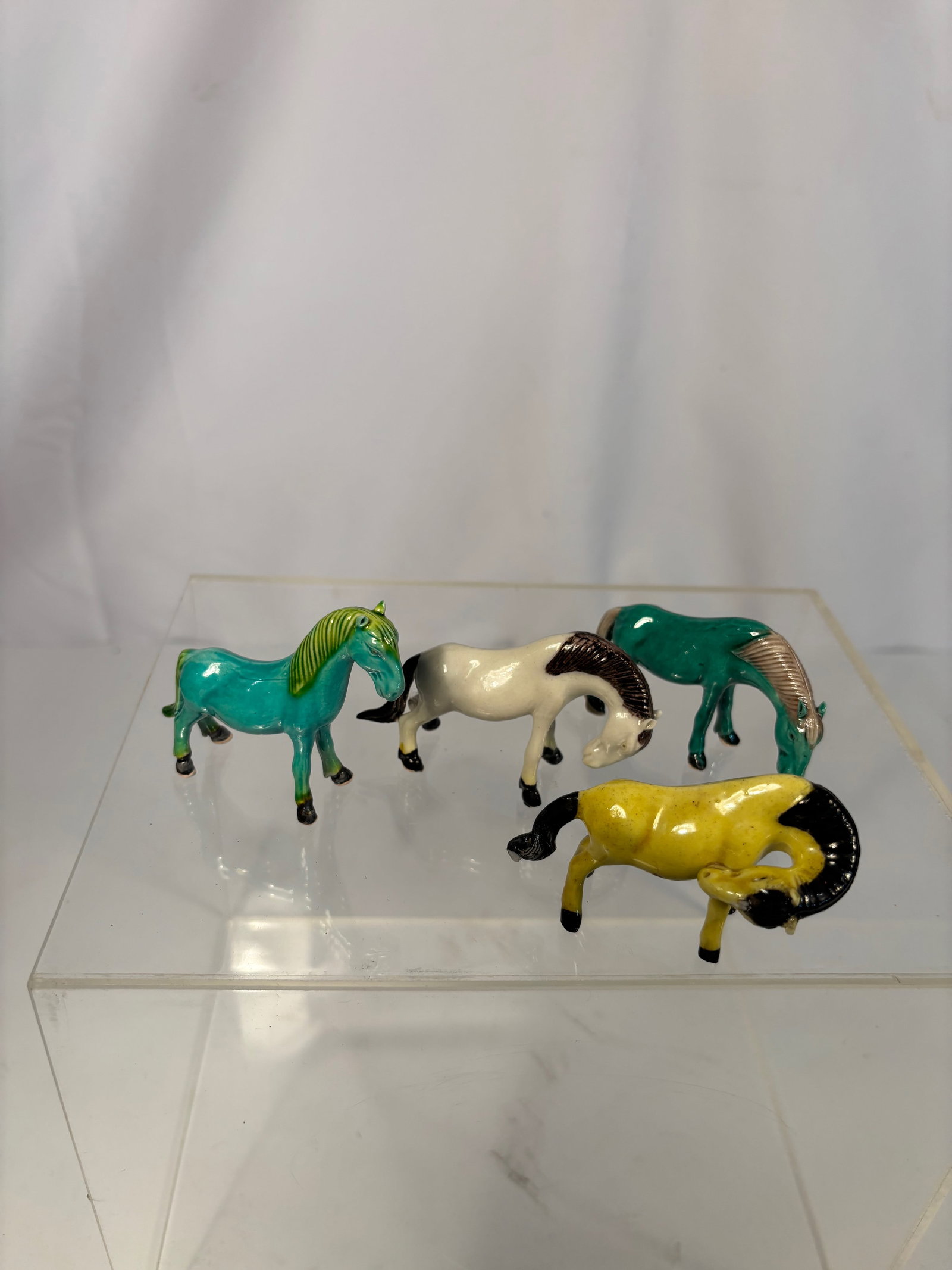 Set of Four Miniature Chinese porcelain Enamel Horses: Early 20the century, A delightful group of four miniature horses, each finely modeled in various poses with colorful enamel glazes. The bodies display rich turquoise, white, emerald green, and yellow 