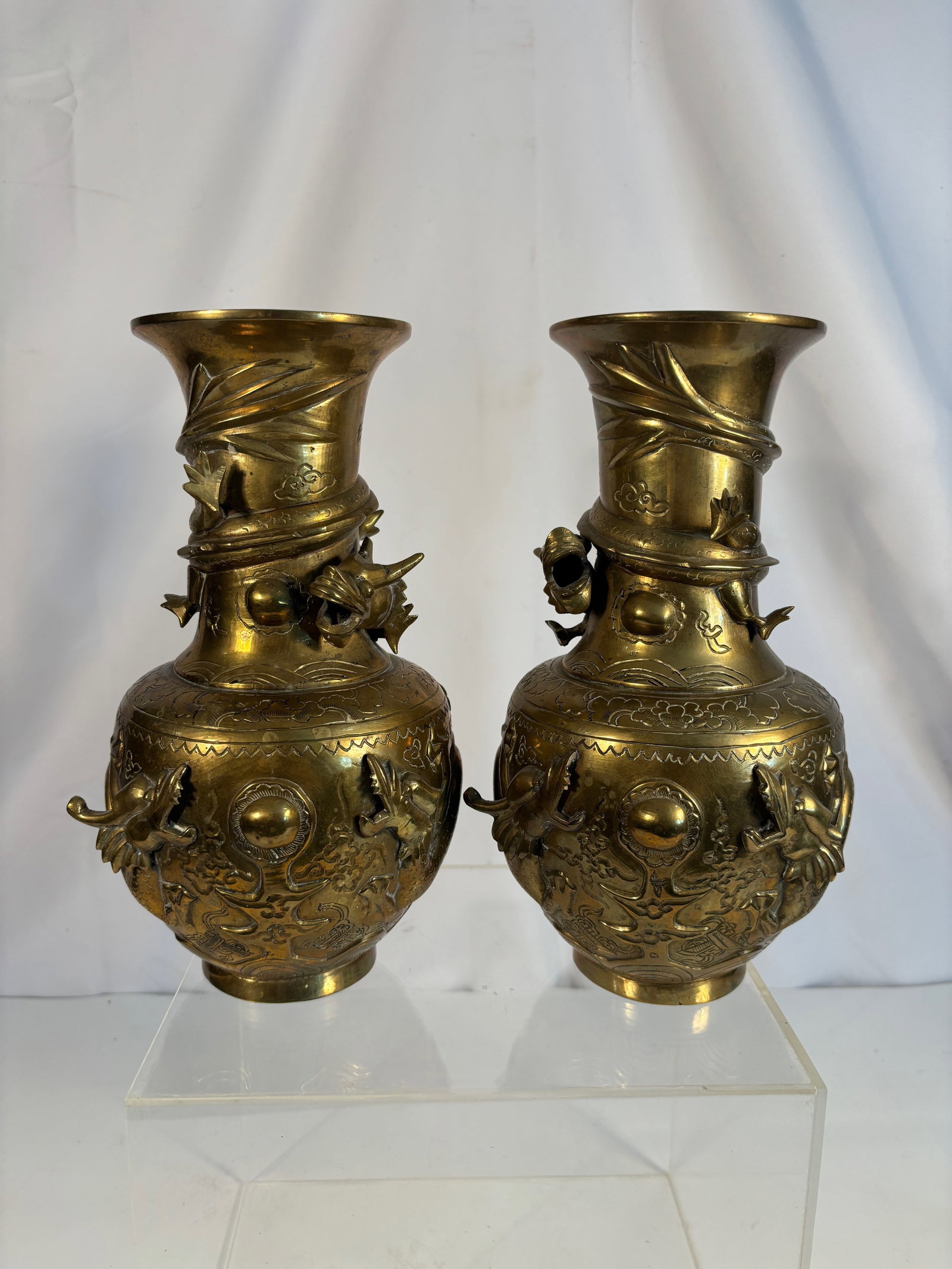 Pair of Japanese Gilt-Bronze Dragon Vases, Signed, Meiji–Taish? period: Late 19th century to early 20th century; A fine and detailed pair of Japanese gilt-bronze vases, each of baluster form, intricately cast in high relief with writhing dragons amidst clouds, chasing the