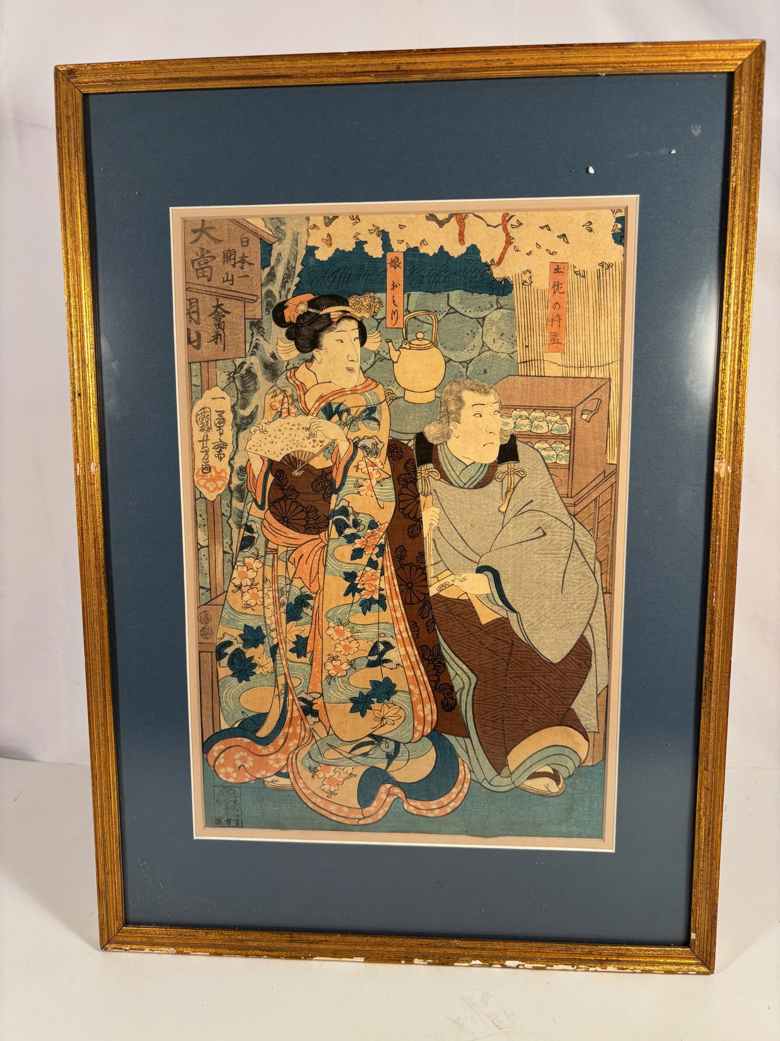 Utagawa Kuniyoshi (1797–1861),Beauty in Spring –Edo period woodblock print: A finely detailed Edo-period woodblock print by Utagawa Kuniyoshi (1797–1861), depicting an elegant beauty beneath blooming cherry blossoms. The woman holds an open fan and gazes thoughtfully to the