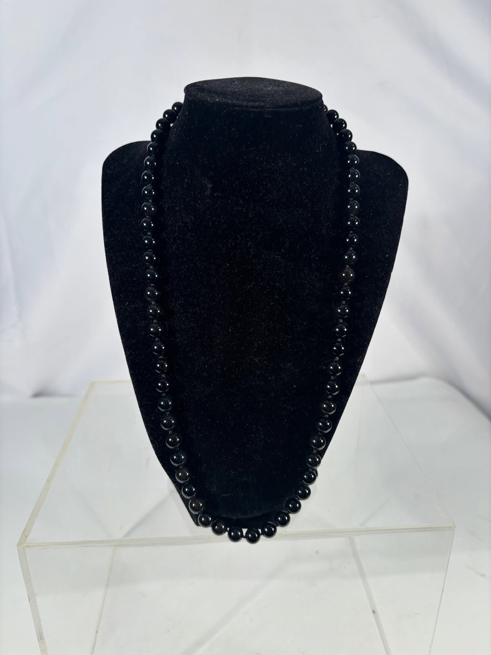 Vintage Onyx Bead Necklace with Silver-Tone Spacers, 23 Inches: A vintage bead necklace composed of round onyx beads, measuring approximately 23 inches in length. The strand is accented with silver-tone metal spacer beads (material untested). The onyx beads displa