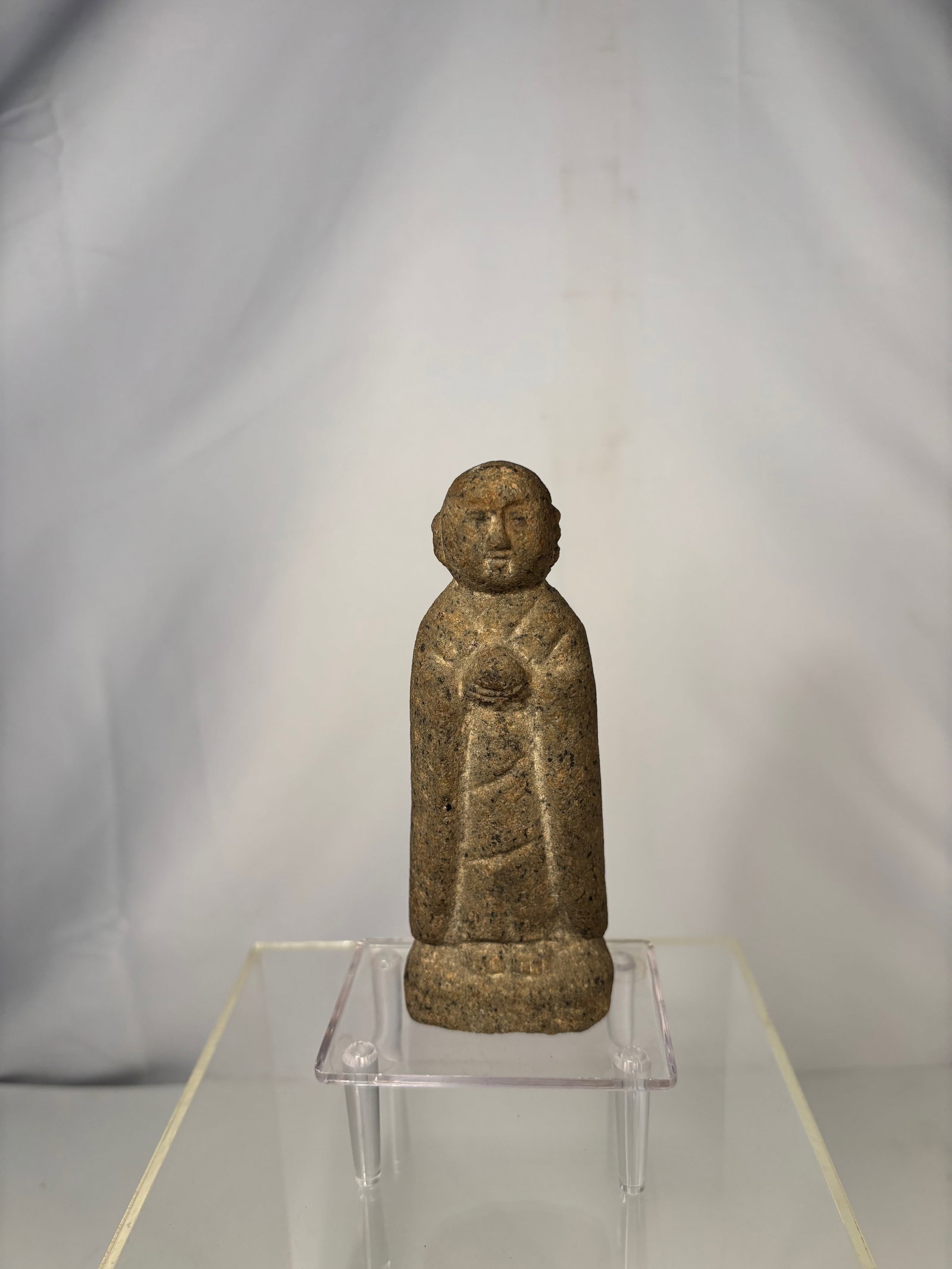 A Japanese Stone Jiz? Bosatsu Figure, Edo–Meiji Period: A Japanese stone Jiz? Bosatsu devotional figure, dating from the Edo to early Meiji period. The figure is carved in standing form with a calm, contemplative expression, wearing a simple monk’s robe 