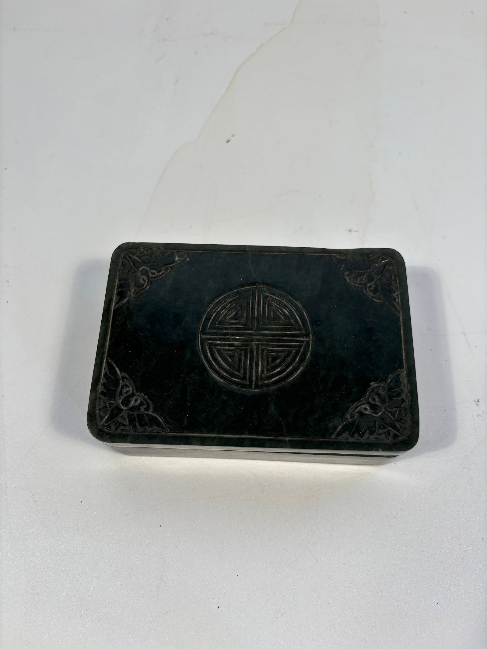 A Chinese hand carved green jade box: Qing Dynasty (1644-1912), Dimensions? Length: 5 inches ; Width: 3.25 inches ; Height: 1.5 inches.