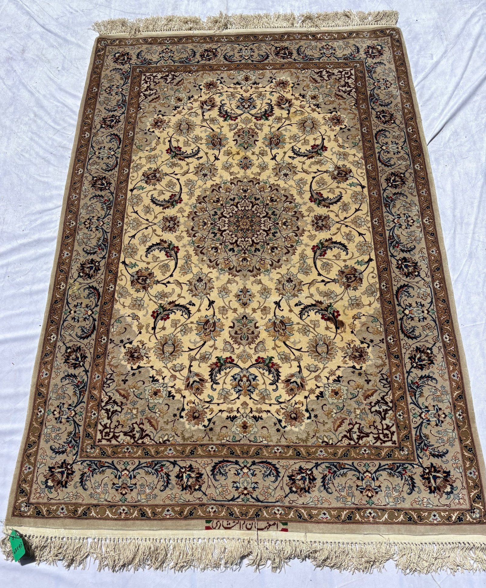 Signed Persian Esfahan Silk Rug, 68 x 43 in.: Featuring an ivory field centered by an elaborate floral medallion amidst scrolling arabesques, palmettes, and intricate floral vinery within multiple decorative borders. Executed in refined ivory, ta