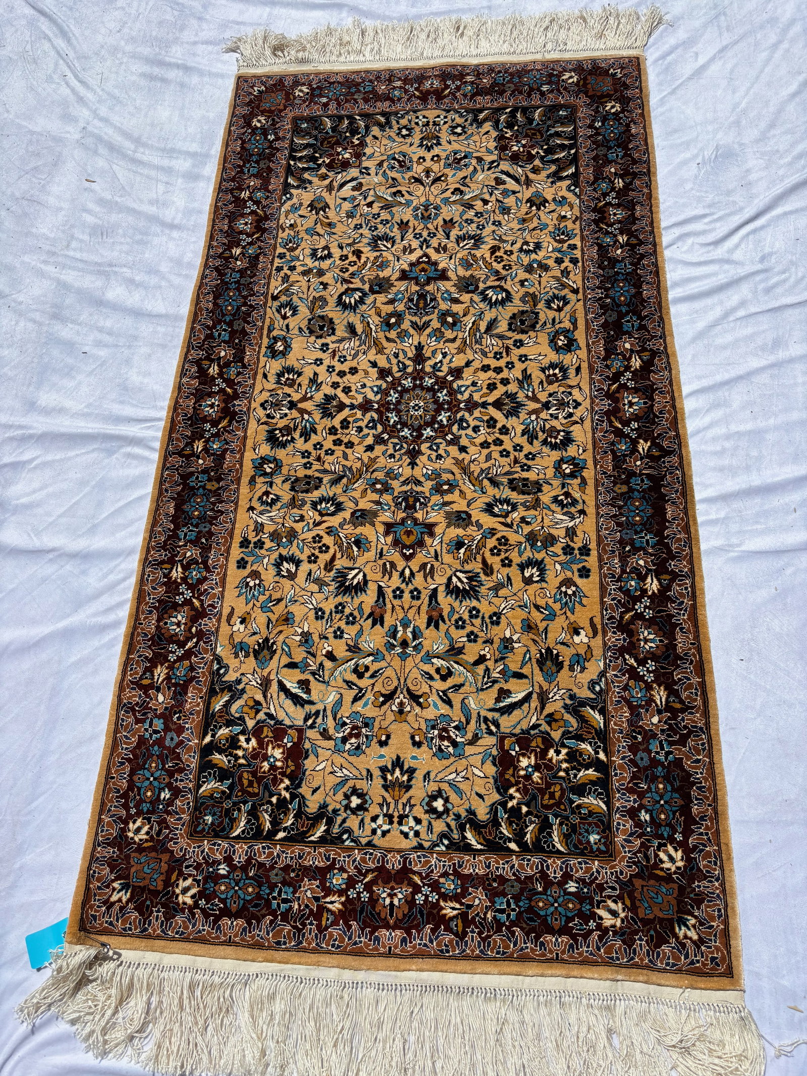 Persian Esfahan Silk Rug, 68 x 30 in.: Featuring an ivory field centered by an elaborate floral medallion amidst scrolling arabesques, palmettes, and intricate floral vinery within multiple decorative borders. Executed in refined ivory, ta