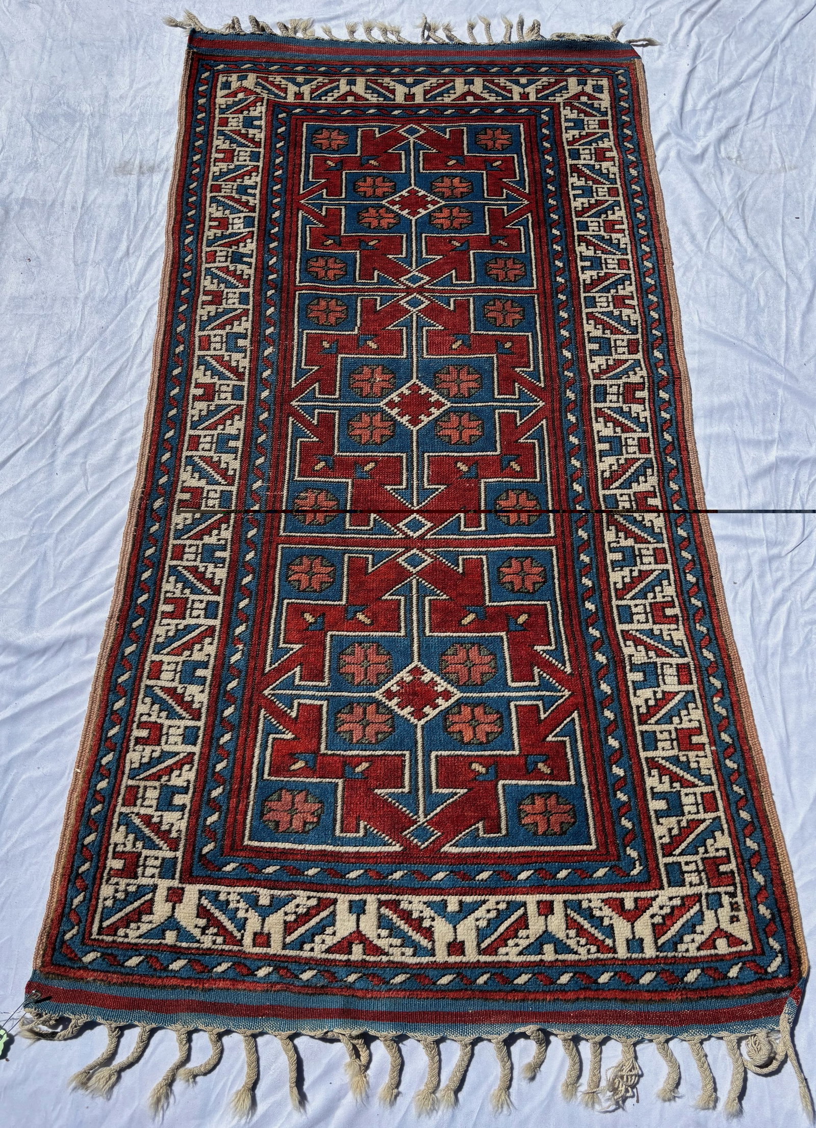 Caucasian Style Geometric Runner Rug 77 x 37 in.: Hand-knotted wool runner featuring bold geometric medallions in vivid red, blue, and ivory tones with angular border motifs in the Caucasian tradition. Strong visual contrast and tribal-inspired desig