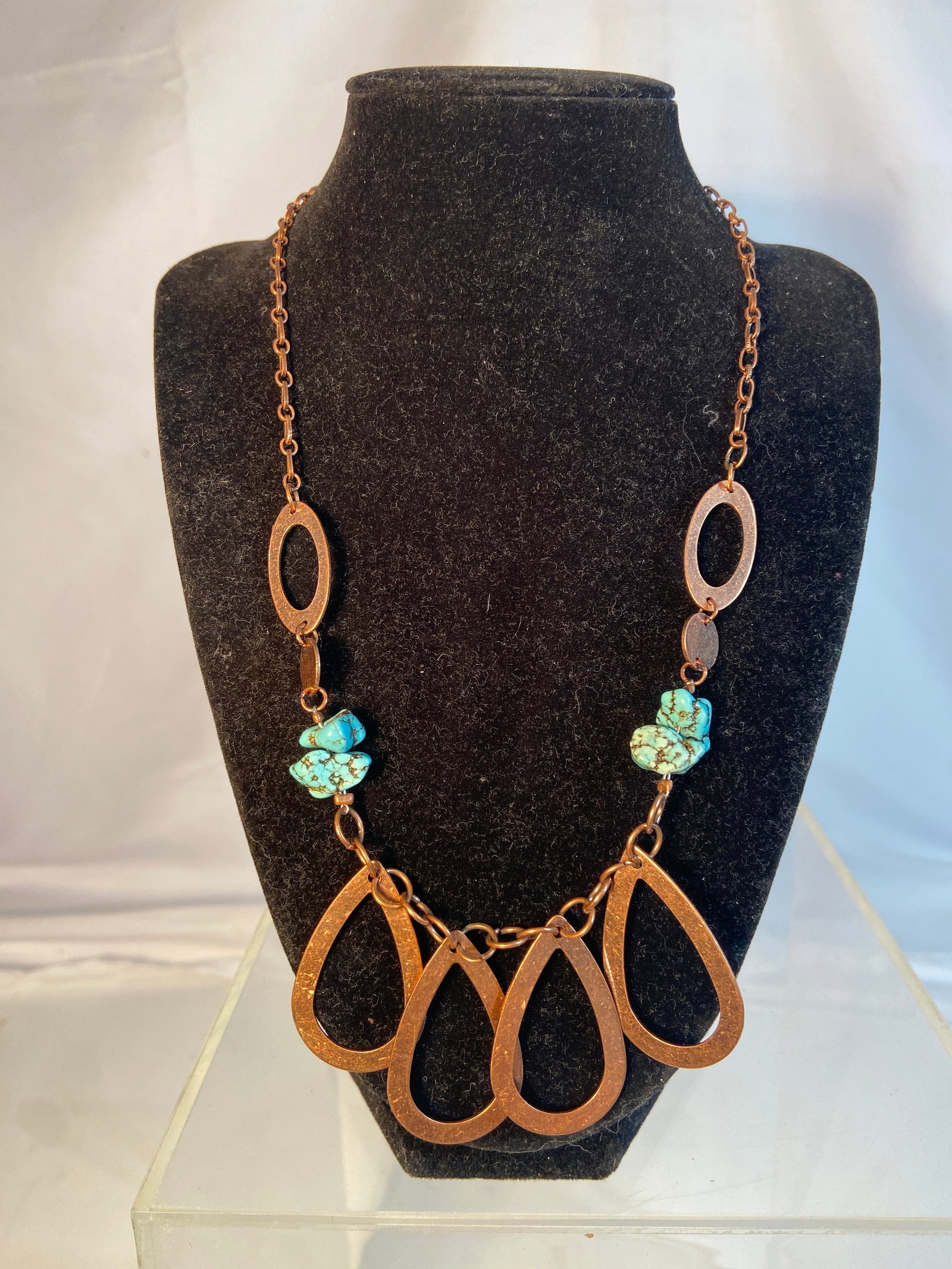 Vintage Southwestern Style Turquoise Tone Statement Necklace: Vintage Southwestern style statement necklace featuring turquoise-tone nugget accents and large copper-tone openwork teardrop pendants. Suspended from a linked copper-tone chain with toggle clasp clos