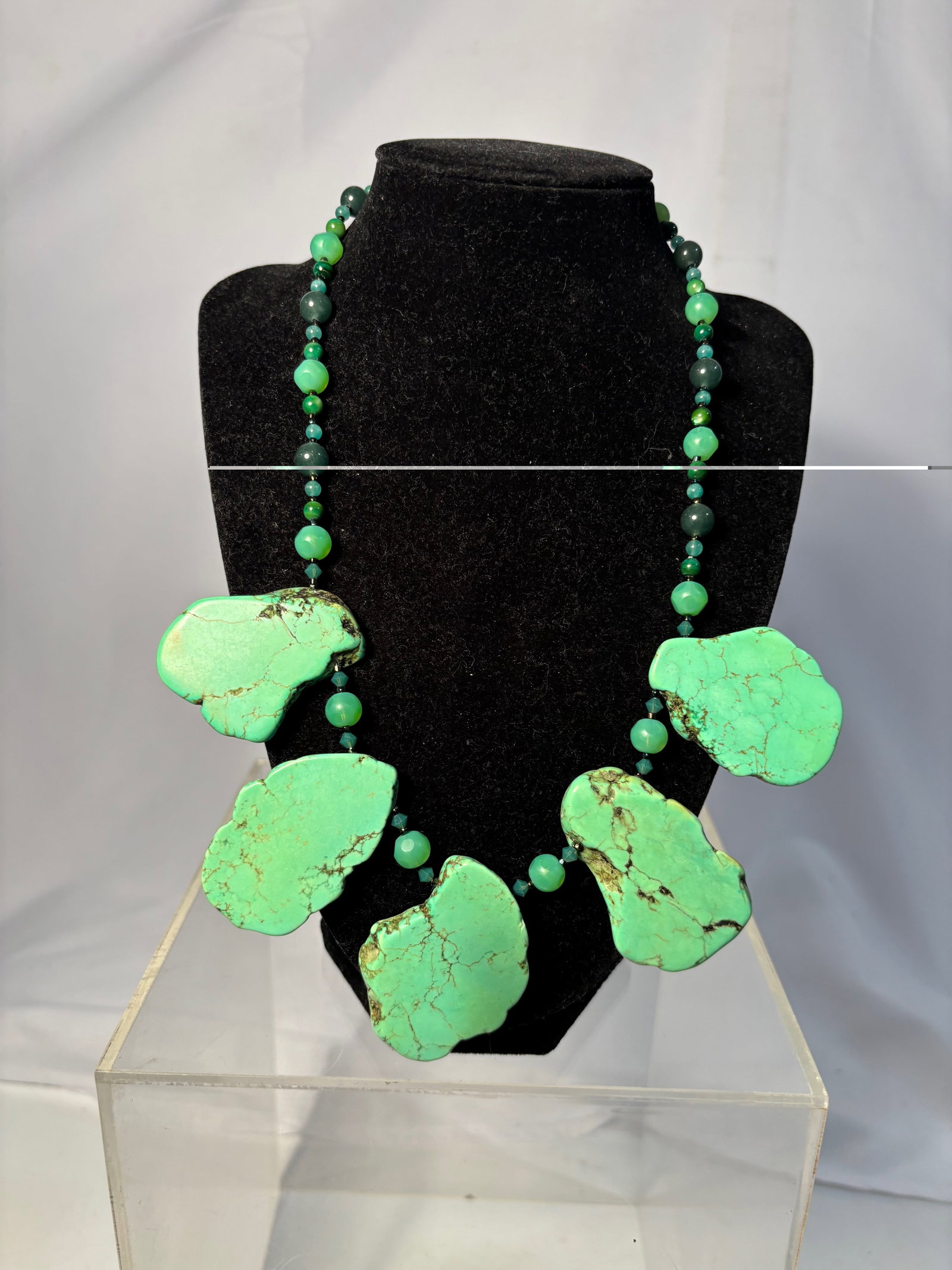 Turquoise Necklace with Large Irregular Slab Beads, Southwestern Boho: A bold statement necklace composed of green beads with large irregular slab-form turquoise The piece features organic shapes with natural-style matrix patterning and graduated bead sizes, creating a s