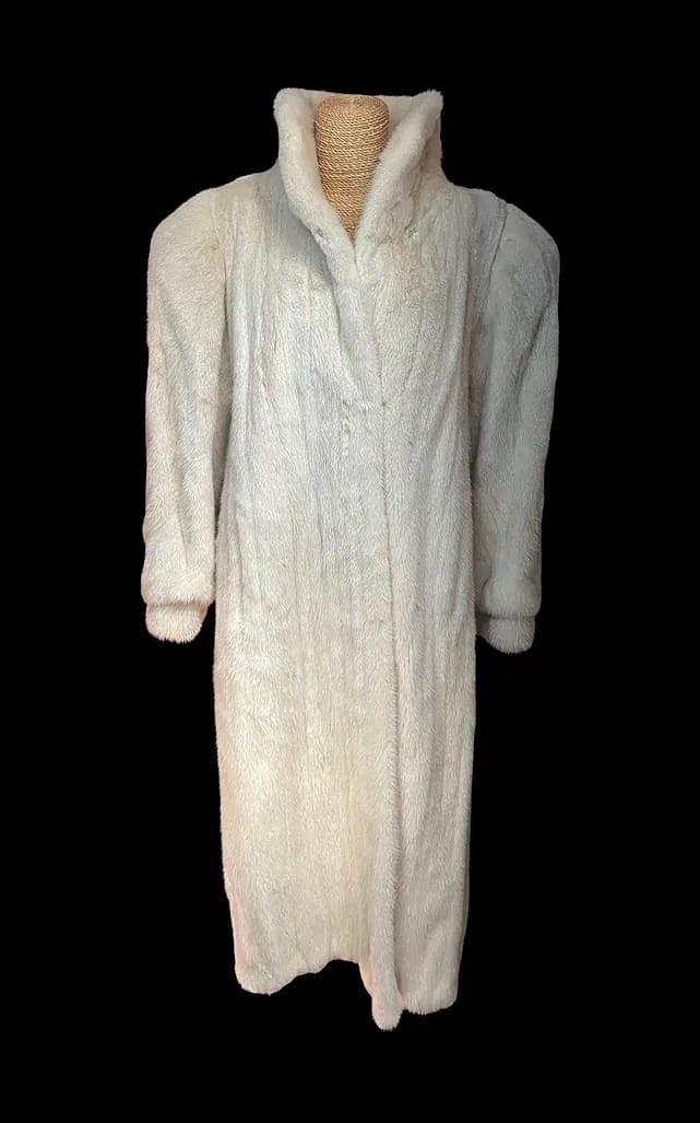 Dorette Klein White Mink Full Length Fur Coat: Elegant vintage full-length white mink fur coat by Dorette Klein. Featuring a classic stand collar, concealed front closures, and luxurious vertically matched mink pelts. The coat displays a soft ivor