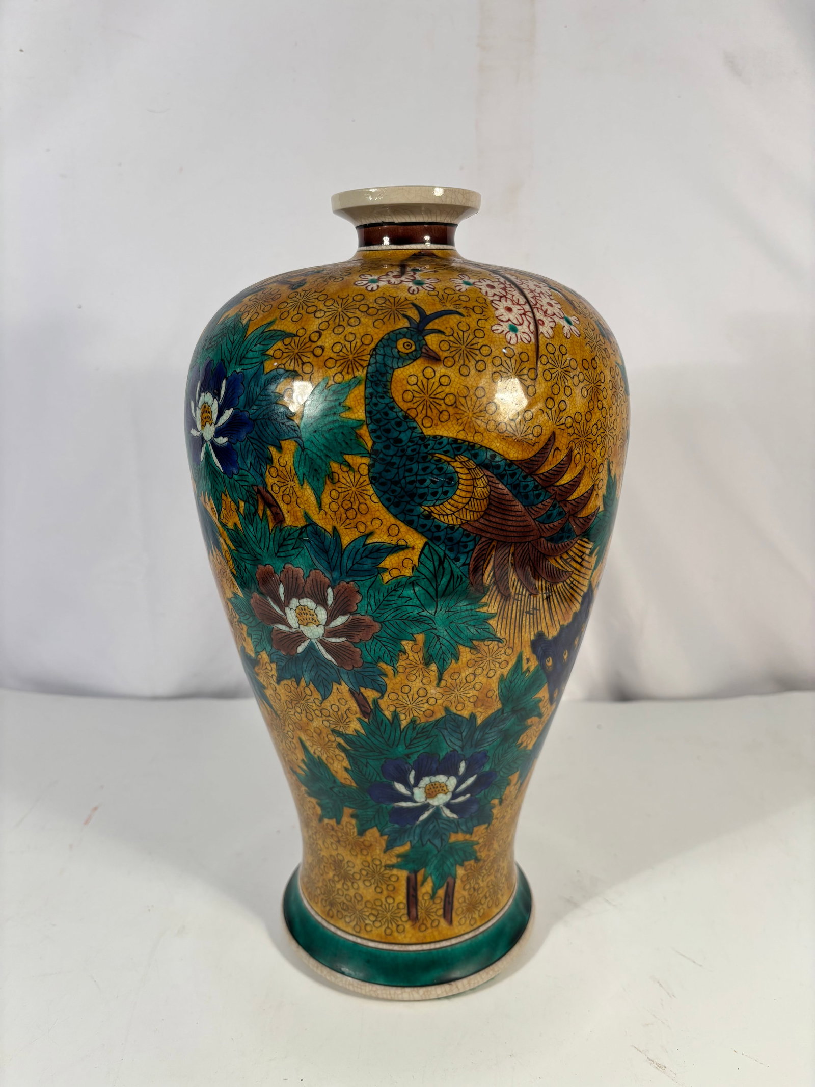 A Japanese Kutani Peacock & Peony Floral Gold-Ground Porcelain Vase: A fine Japanese Kutani porcelain cabinet vase, likely dating to the late Meiji to Taisho period, richly decorated in a dense gold-ground floral pattern with a prominent peacock among blooming peonies 