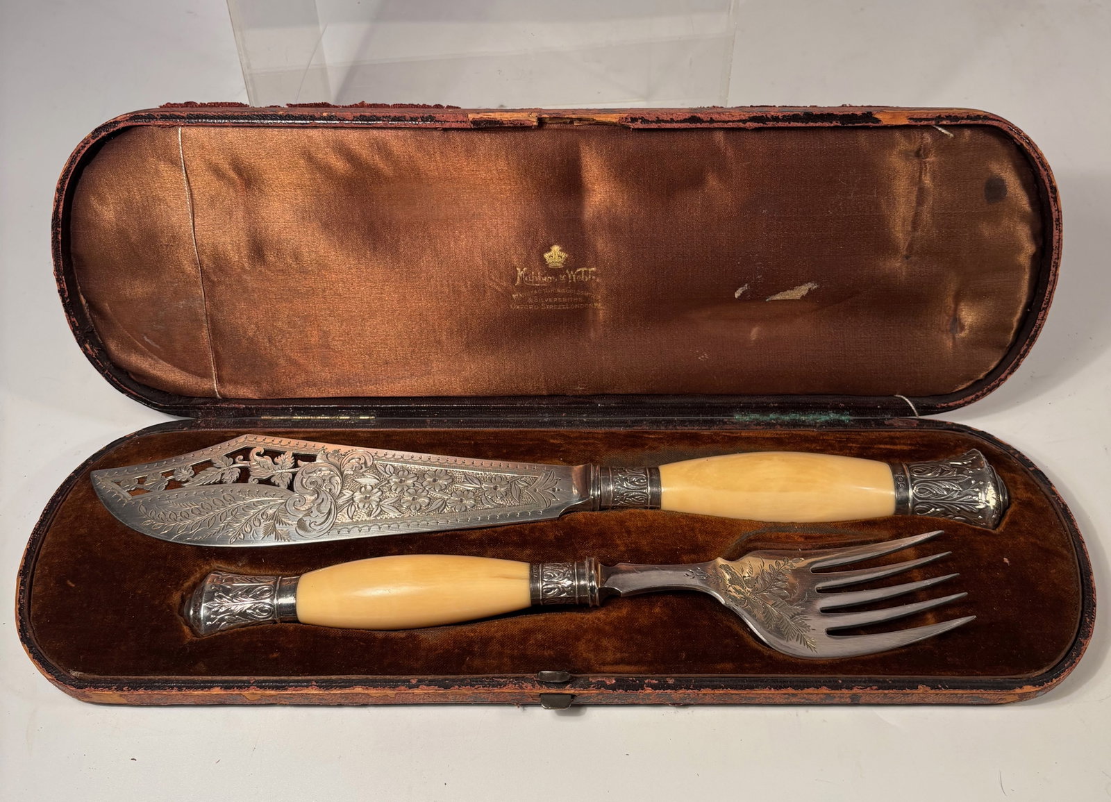 Antique Mappin & Webb Sterling Silver Carving Knife & Fork Set in Case: An antique carving knife and fork set by Mappin & Webb, featuring decorative sterling silver mounts with British hallmarks and natual carved handles. The knife blade and fork are engraved with decorat