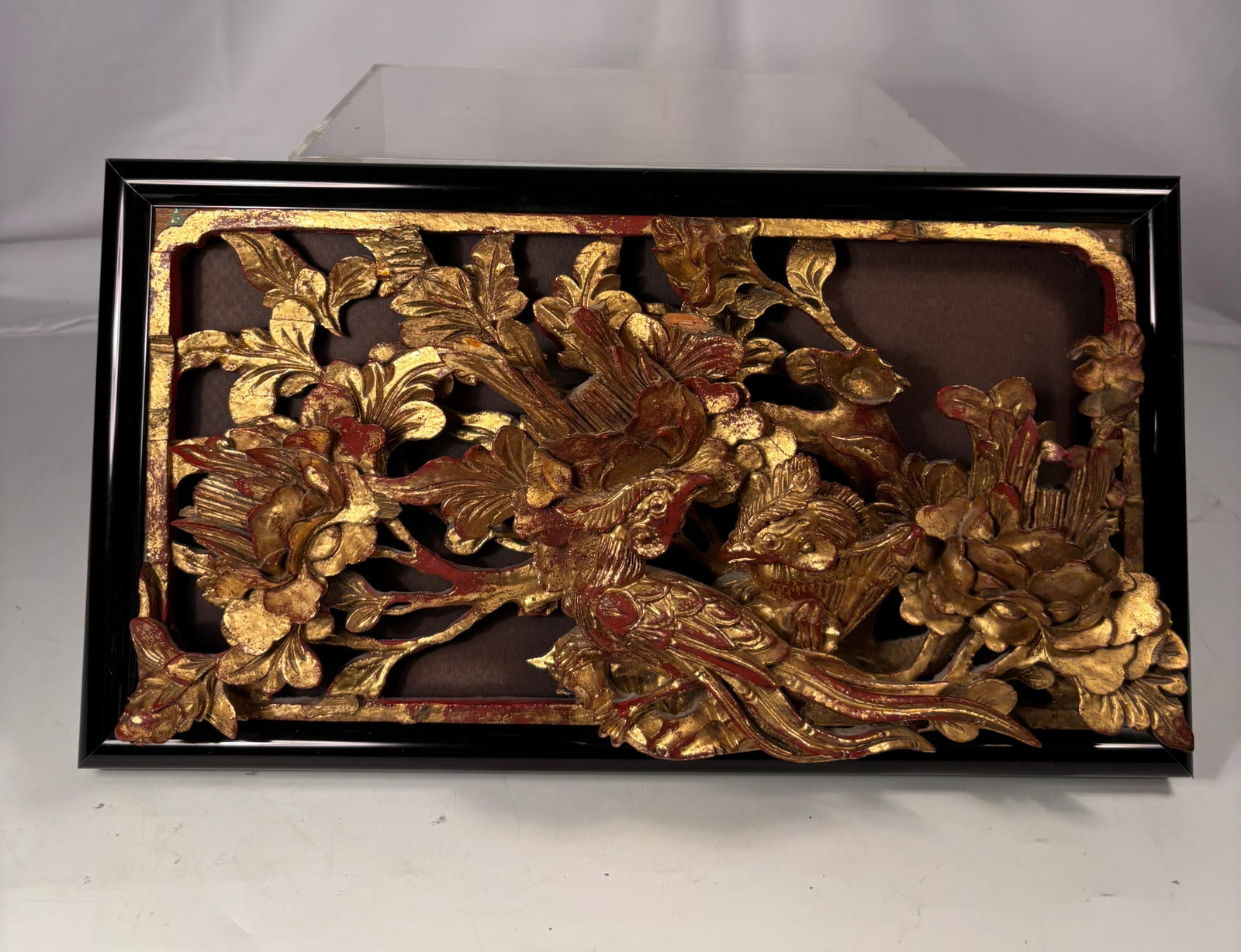 Chinese Giltwood Deep Relief Carved Panel with Phoenix and Peonies, 19th century: Chinese 19th century giltwood rectangular panel, finely carved in deep relief and openwork, depicting a pair of phoenixes amid luxuriant peonies and scrolling foliage. The composition features excepti