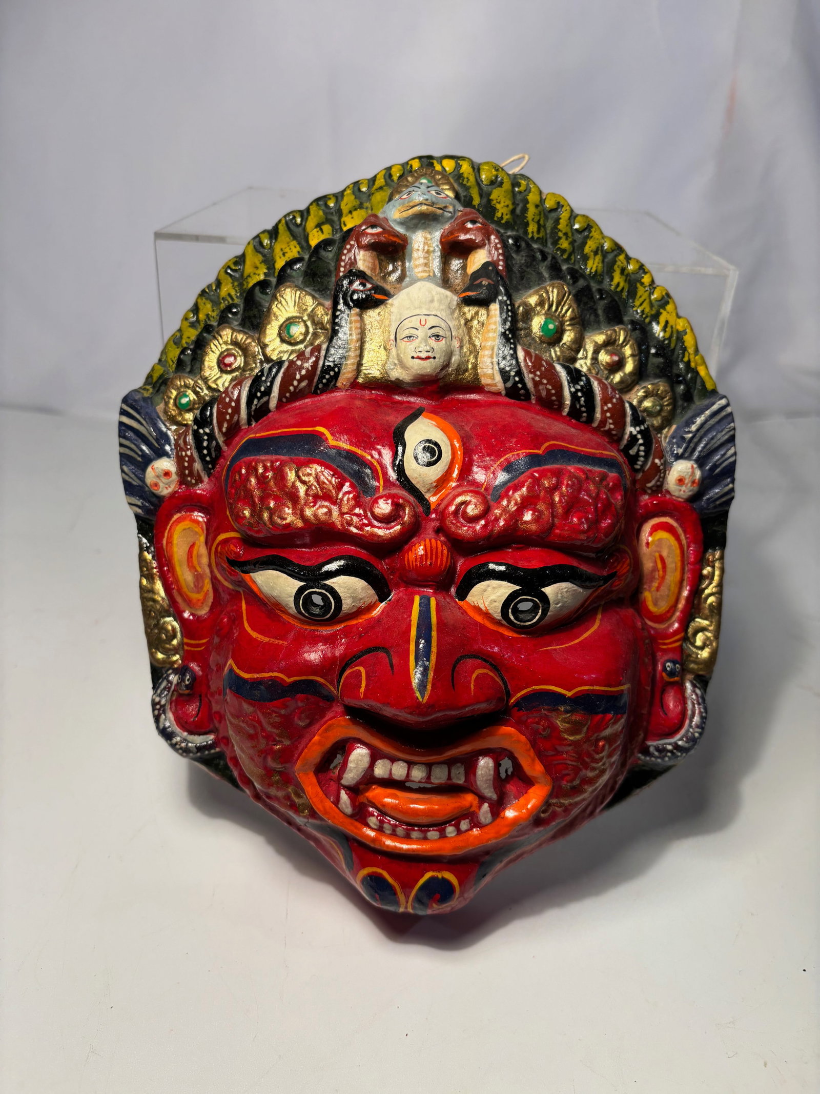 Himalayan Polychrome Dry Lacquer Mask with Naga Crown: This polychrome dry lacquer ritual mask depicts a wrathful deity with fierce expression, bulging eyes, bared teeth, and a prominent third eye to the forehead. The figure is crowned by a multi-headed n
