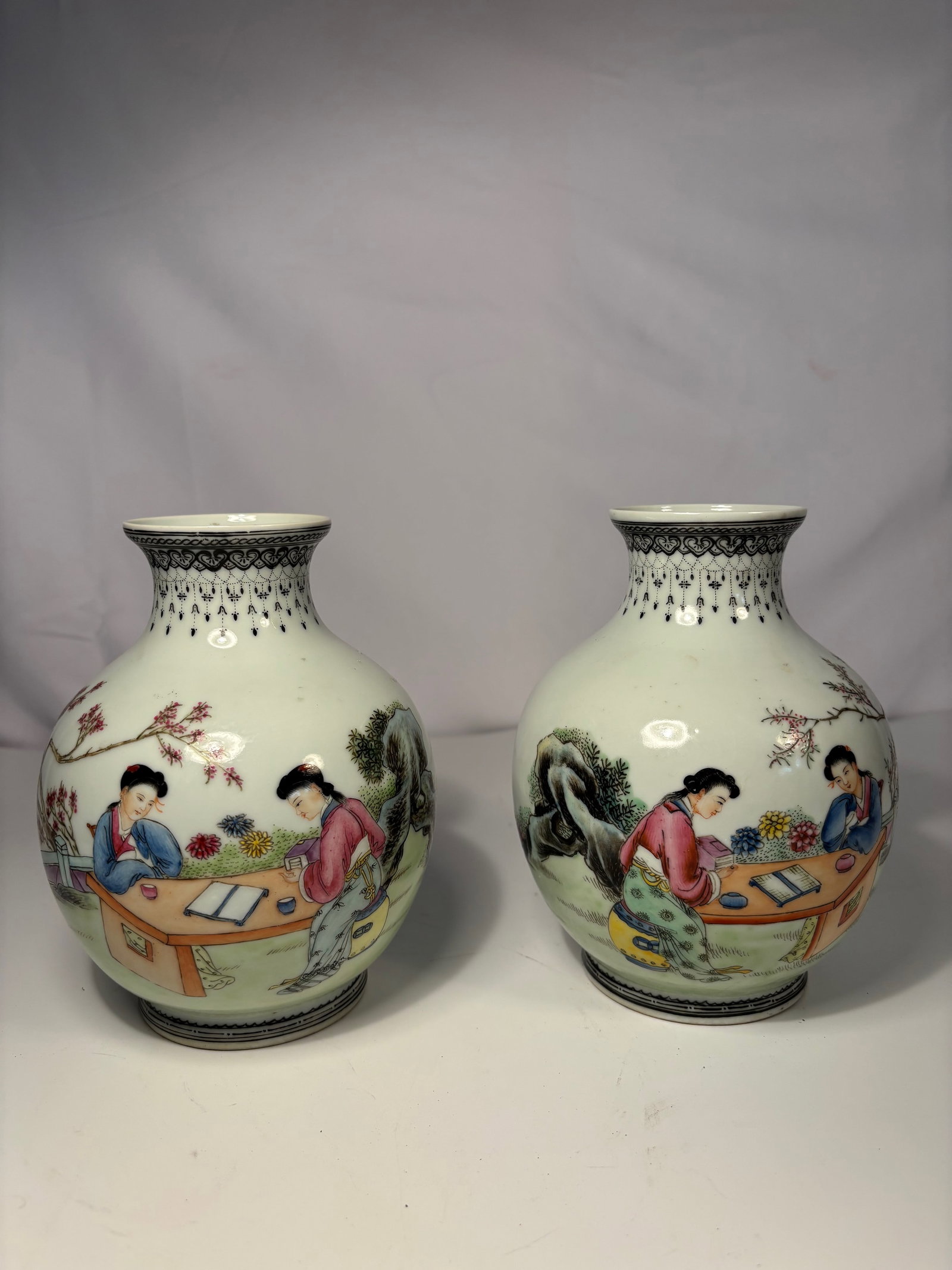 Pair of Chinese Famille Rose ‘Pomegranate Zun’ Vases with "QIANLONG"Marks: Qing dynasty(1644-1912); A fine pair of Chinese famille rose porcelain vases of pomegranate zun form, each with a short flaring neck decorated underglaze with a ruyi-head and lappet border. The globul