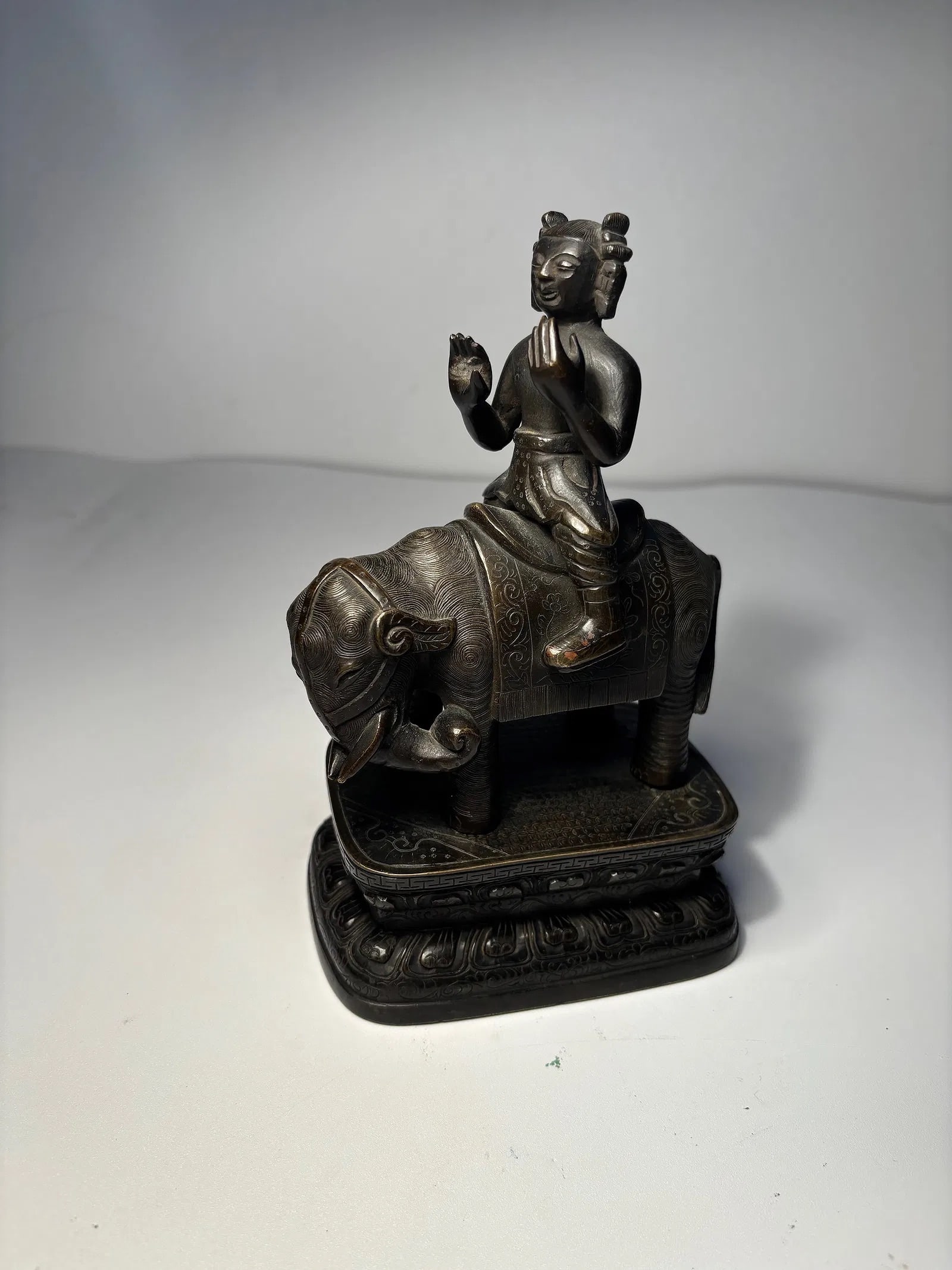 A Chinese bronze figure riding an elephant statue: Ming dynasty(1368-1644) ; he fine patterns on the clothing and the texture on the animal suggest a high level of craftsmanshipProvenance: From an prominent Midwest family collection in US.Dimensions?H