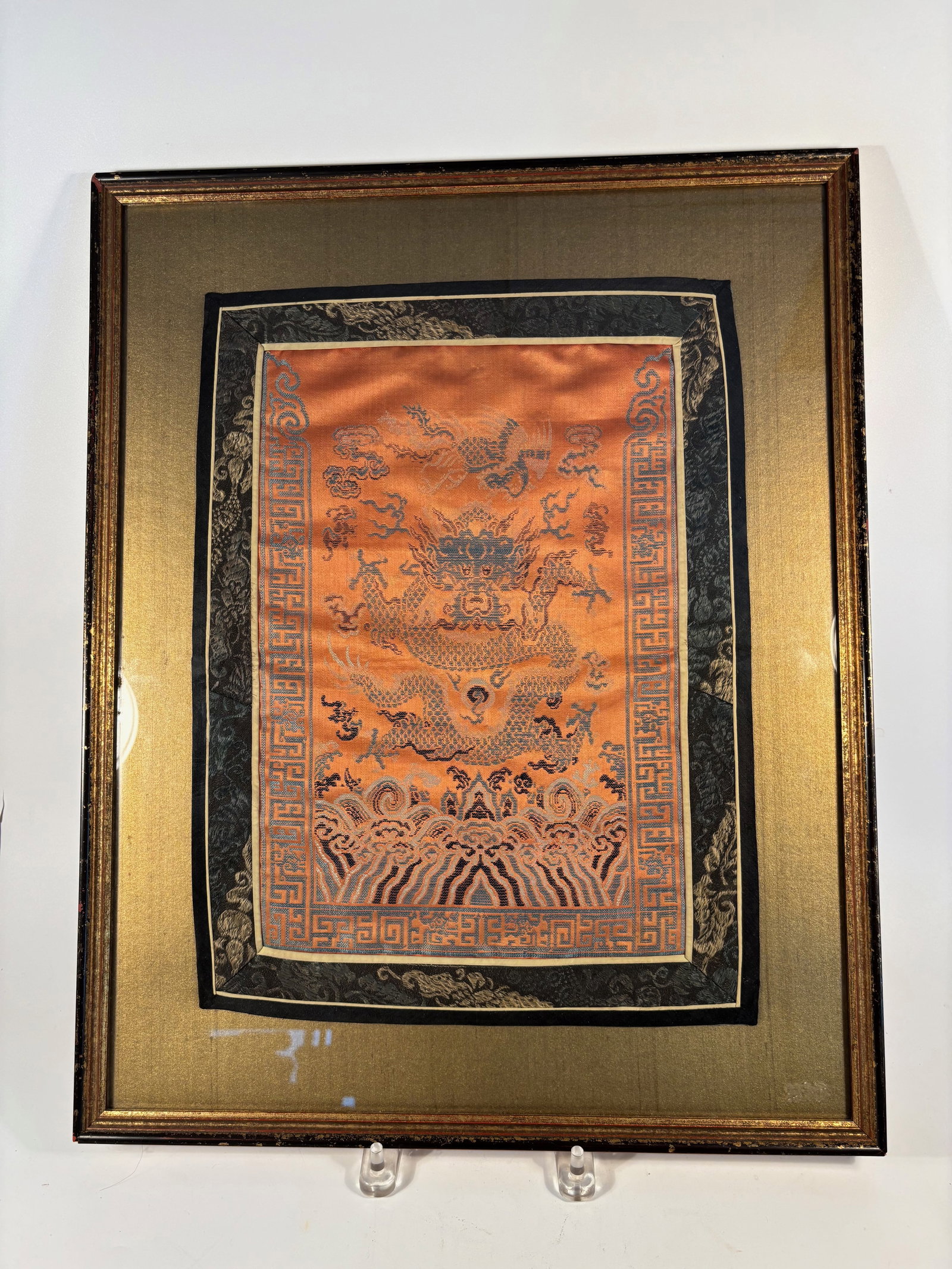 A Chinese Imperial-Style Silk Dragon Panel, Five-Clawed Dragon Amid Clouds: Qing Dynasty(1644-1912); A finely woven Chinese silk textile featuring a five-clawed imperial dragon surrounded by clouds, waves, and auspicious motifs. The dragon is shown chasing the flaming pearl o