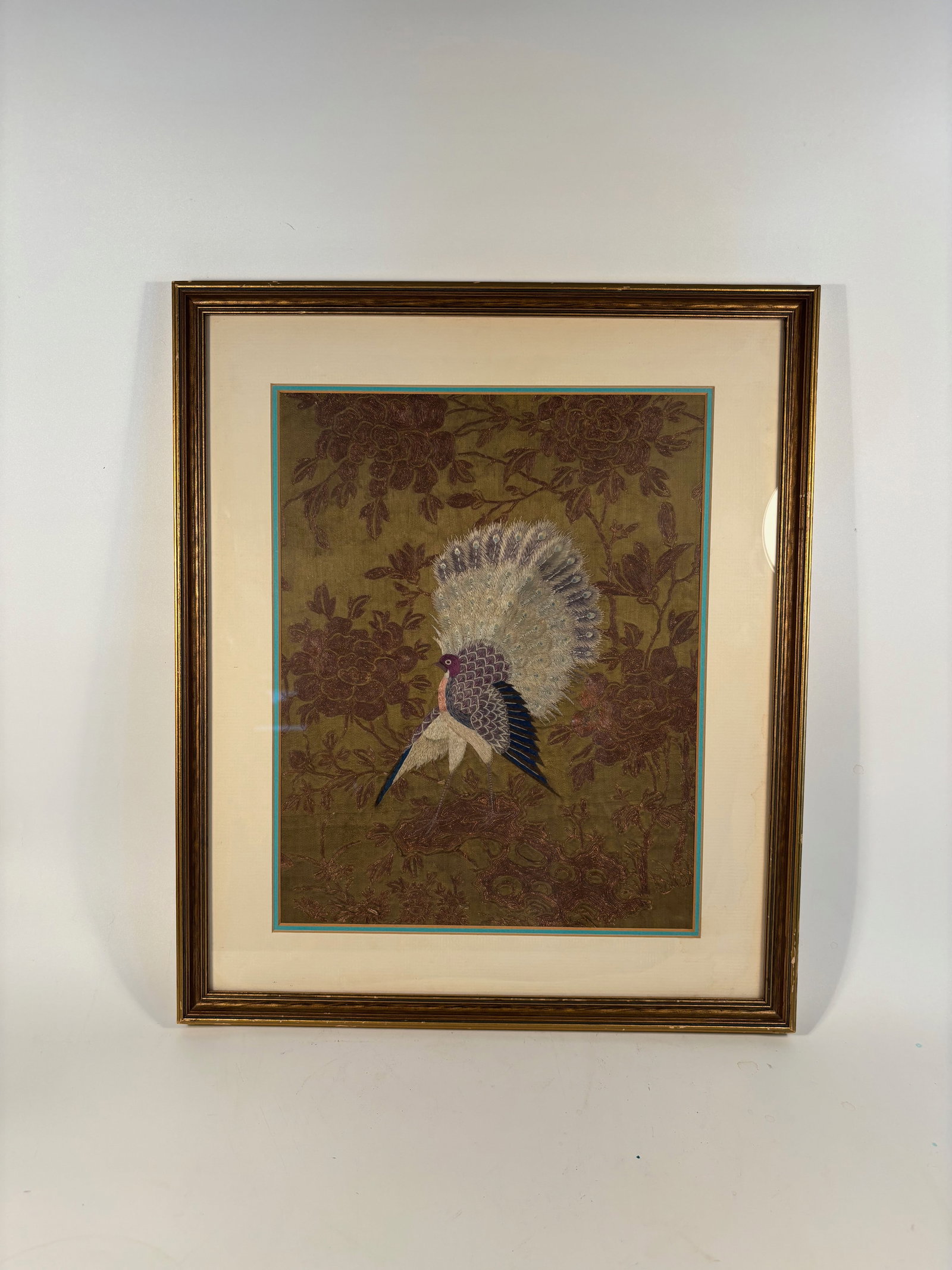 Framed Chinese Silk Embroidery Panels with Birds and Peonies: Qing Dynasty (1644-1912); depicting a vividly colored bird—likely a pheasant or phoenix—amid blooming peonies and foliage. Executed in silk thread on a golden-brown ground, the panels showcase del