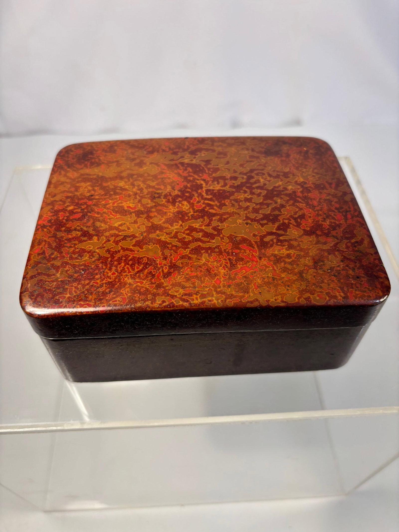 A Chinese Polychrome “Pineapple?? Lacquer Box: Qing Dynasty(1644-1912); Of rectangular form, the box finely finished in rich boluo qi (????), or “pineapple lacquer,” characterized by its naturally mottled surface of mingling red, amber, an