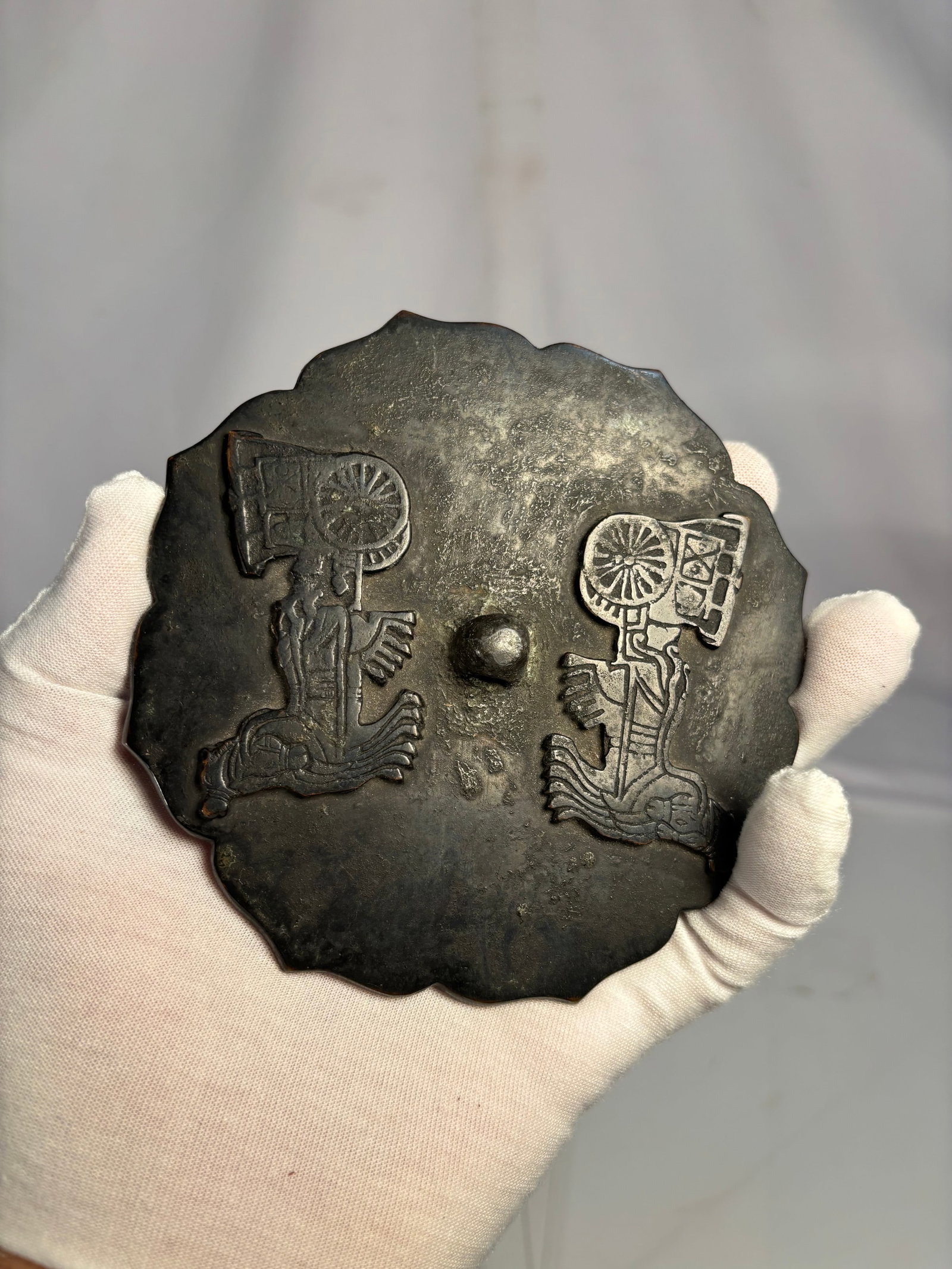 Korean Goryeo Bronze Mirror of Eight-Lobed Form, possibly 10th–14th Century: Korean bronze mirror dating to the Goryeo Dynasty (918–1392). Cast in an eight-lobed floral form with a central suspension knop and relief decoration depicting stylized figures. Mirrors of this type