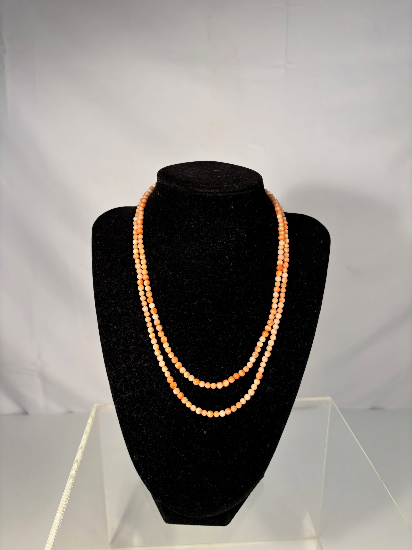 Vintage Natural Coral Bead Necklace: A vintage strand of natural coral beads, finely polished and ranging in tone from soft peach to salmon-orange. Dimensions?The necklace measures approximately 34 inches in length. Weight: 18.3gram.