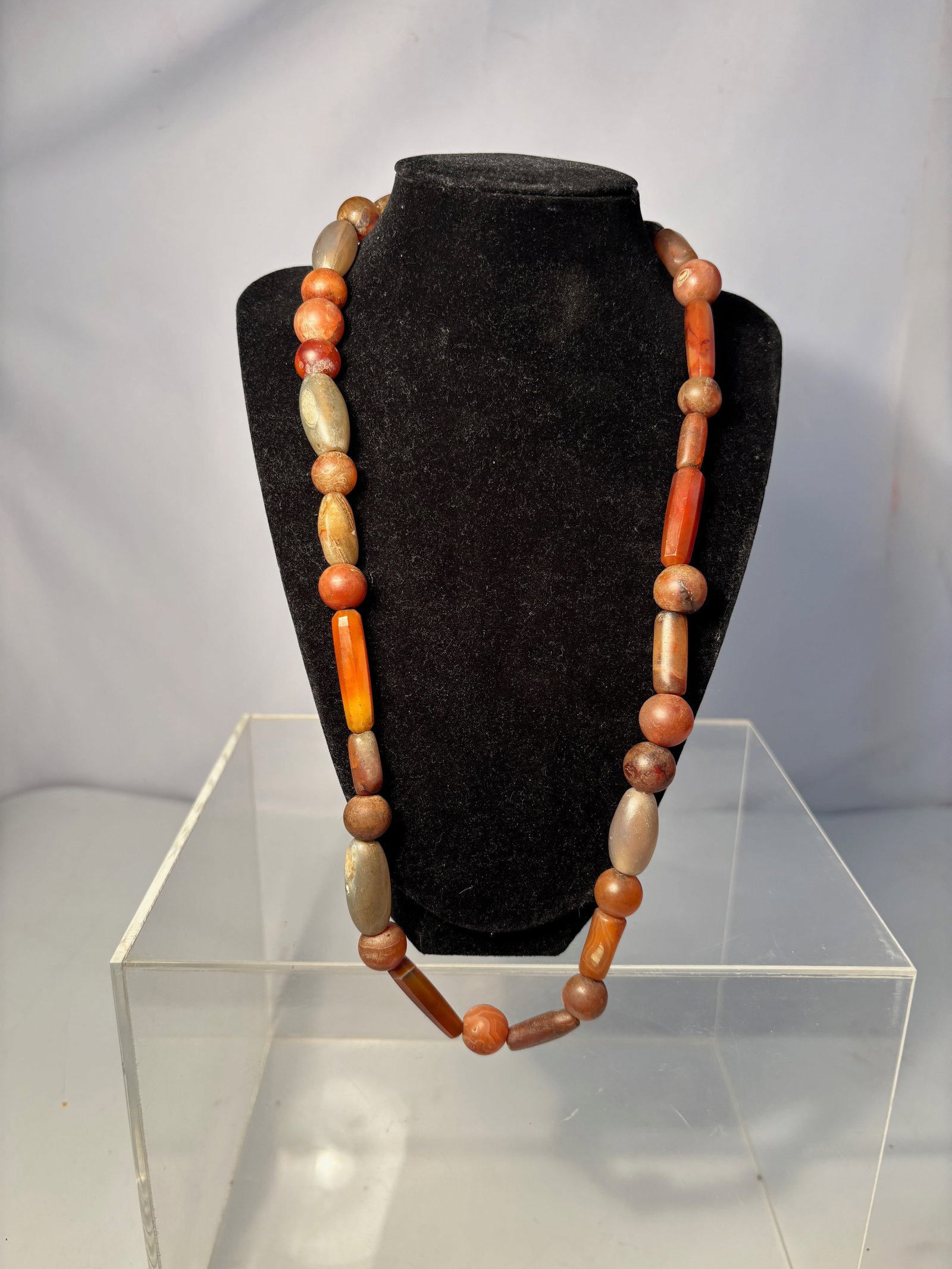 An Ancient Indo-Tibetan / Himalayan / West African carnelian trade beads necklace: The beads are made from natural orange and brown carnelian agate. • The necklace features beads in various shapes and sizes. Agate was historically used as a trade item, jewelry, and amulet praye