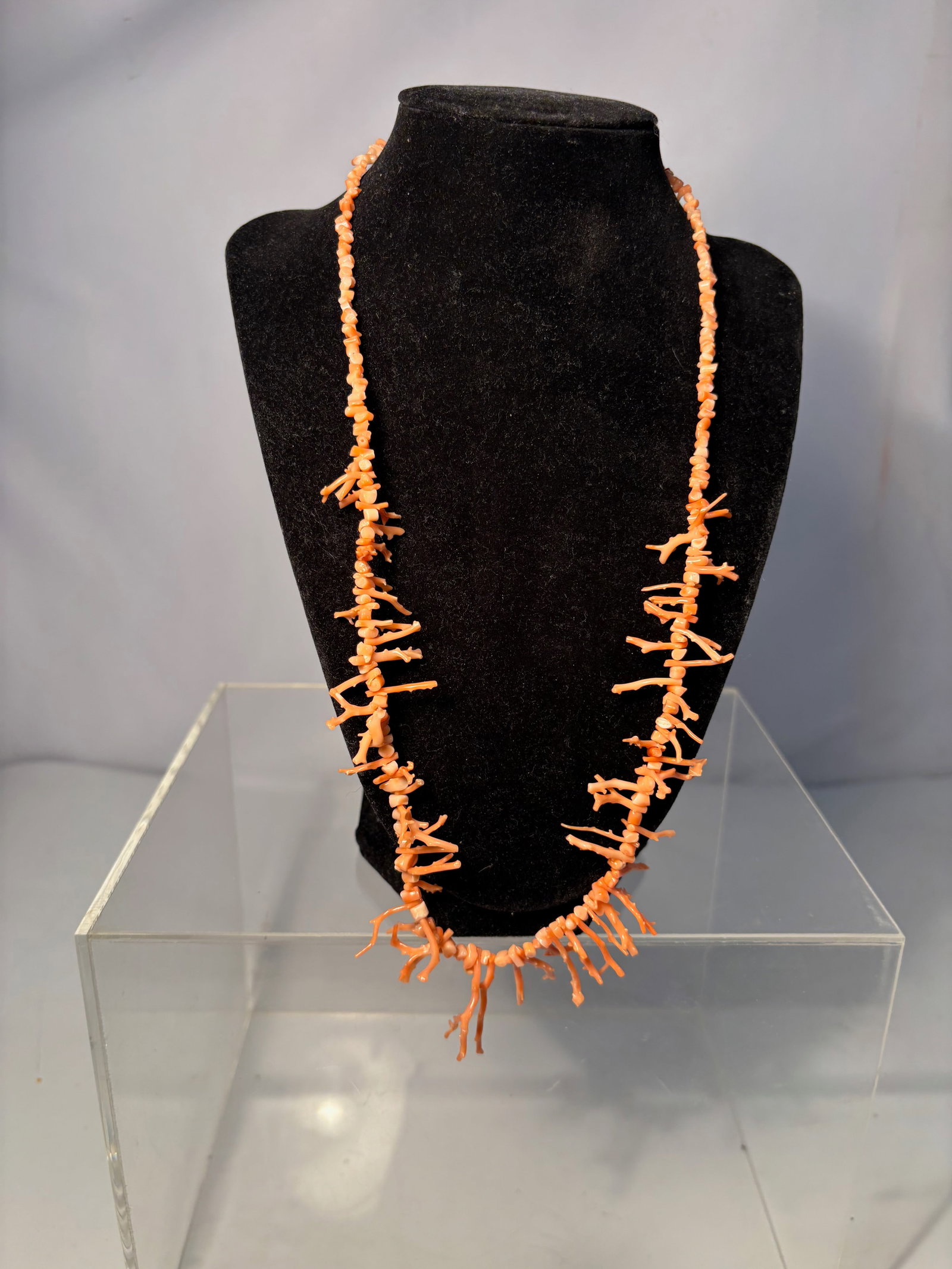 A Mediterranean Natural Branch Coral: Natural branch coral necklace composed of irregular coral segments retaining their organic twig-like form, strung to create a continuous necklace. The coral displays natural orange-salmon coloration a