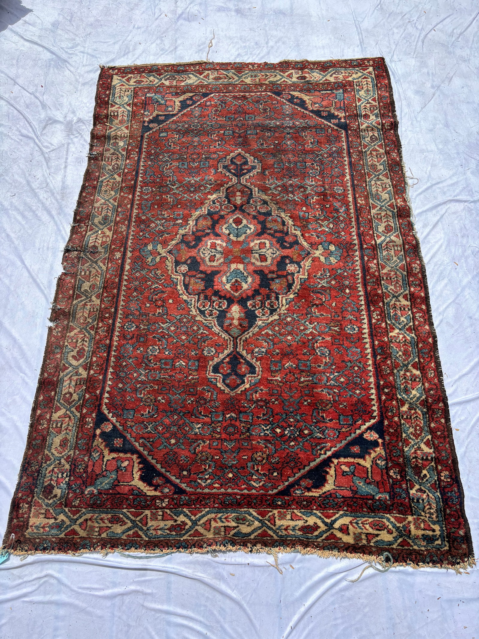 Antique Hand-Knotted Persian Hamadan Style Rug 82 x 51 inches.: Antique hand-knotted Persian Hamadan-style rug featuring a rich red field with geometric central medallion, intricate allover motifs, and stylized borders in navy, ivory, and light blue tones. Traditi