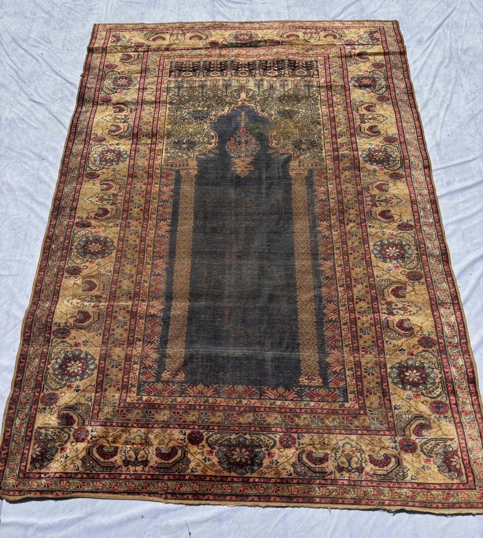 Antique Persian Silk Prayer Rug 67 x 47 in.: Hand-knotted silk rug with traditional prayer niche design on a dark navy field, surrounded by intricate floral and boteh motif borders in cream, burgundy, and gold tones. Fine silk foundation with de