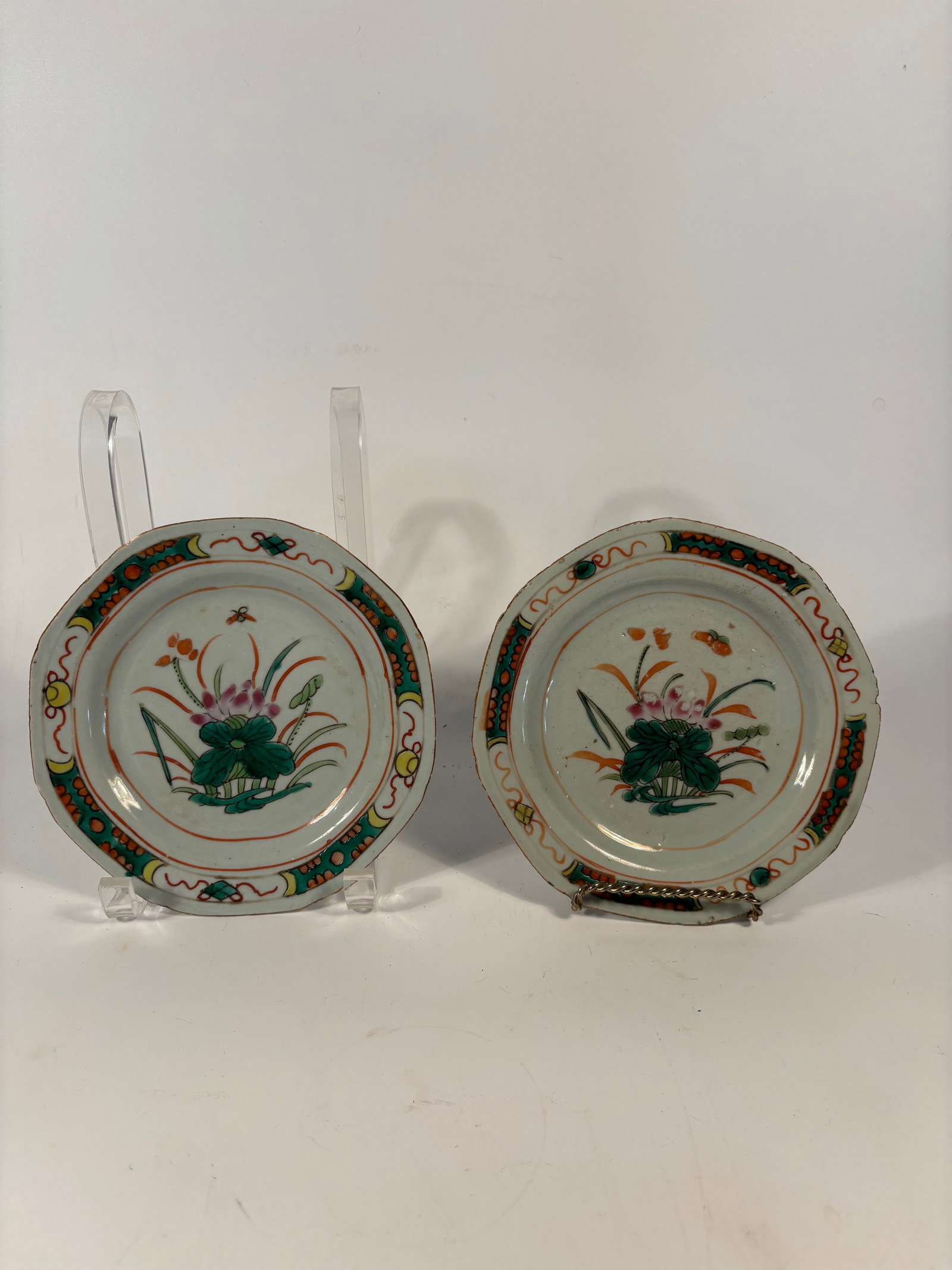 A pair of Chinese Famille Verte porcelain small plates: 17th -18th century; Famille verte (??) palette, with central lotus and foliage, butterflies, and insects — classic for Kangxi export plates. Dimensions?Length: 6.75 inches .