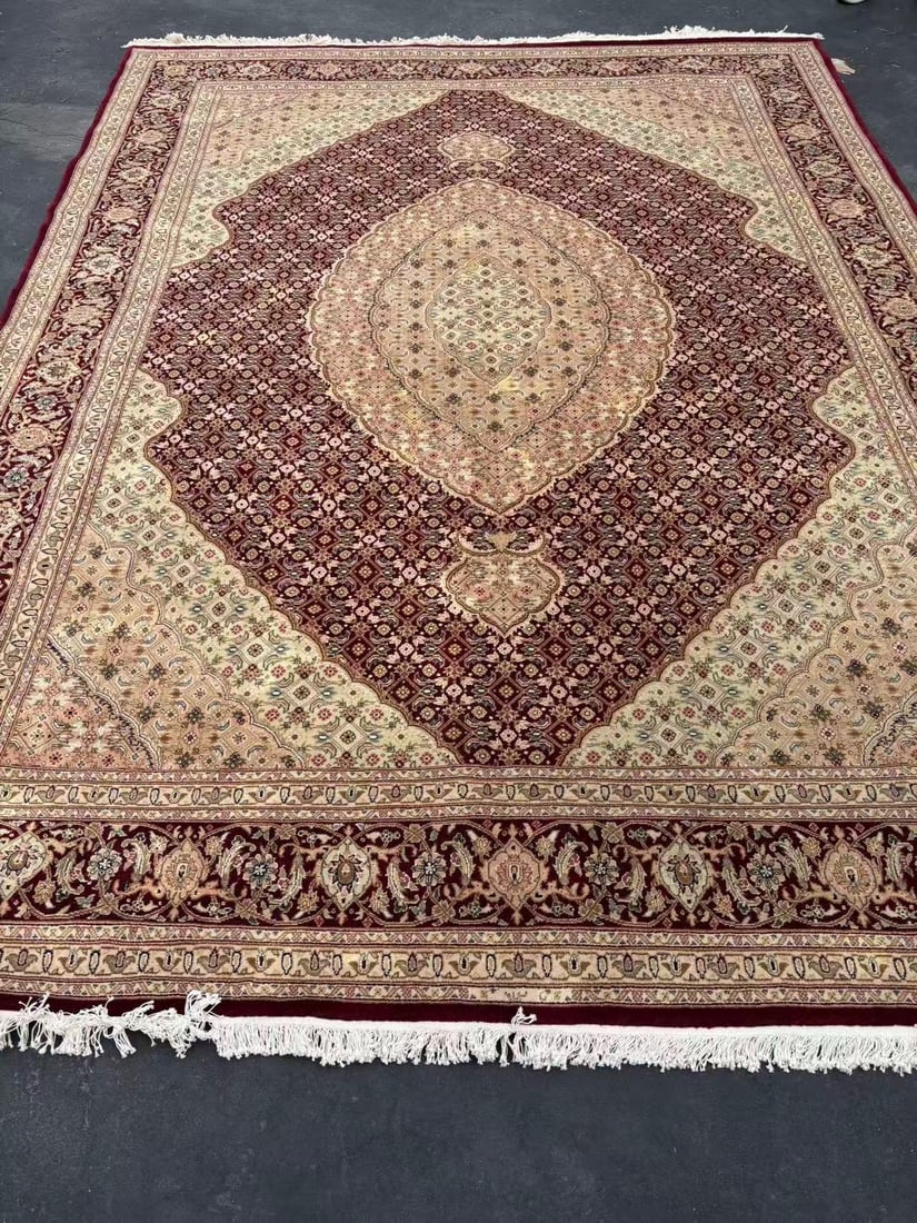 Hand-Knotted Persian Tabriz Style Medallion Room Size Rug 11 ft. 10 in. x 8 ft. 7 in.: Hand-knotted Persian Tabriz-style room-size rug featuring an elaborate central medallion on a deep burgundy field with intricate floral and geometric motifs throughout. Decorated with ivory spandrels 