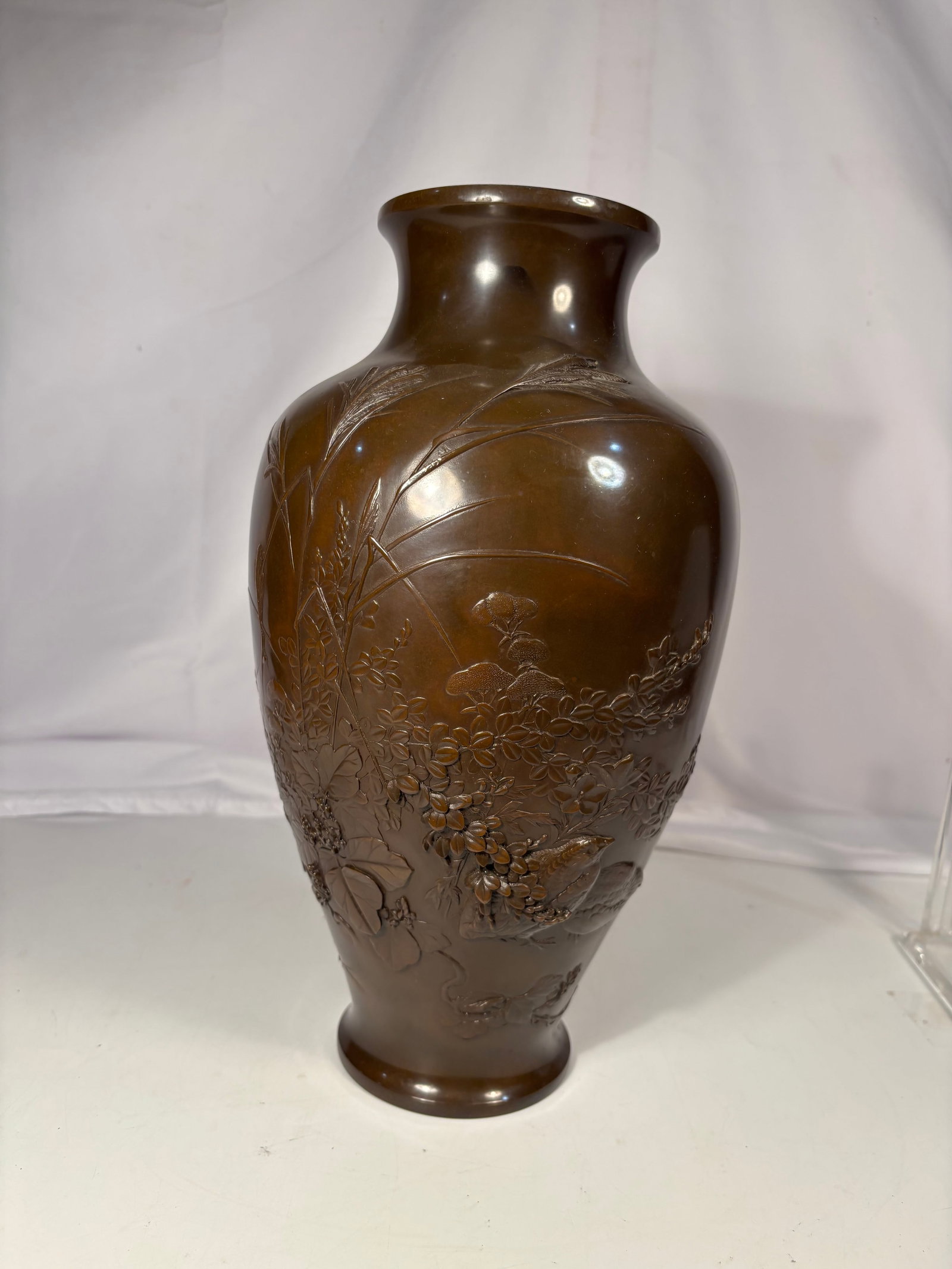 Fine Japanese Bronze Relief Vase with Birds, Flowers & Grasses, Meiji Period (1868–1912?: A finely cast and hand-finished Japanese Meiji period bronze vase of elegant baluster form, featuring a rich chocolate-brown patina. The body is exquisitely decorated in high relief with an intricate 