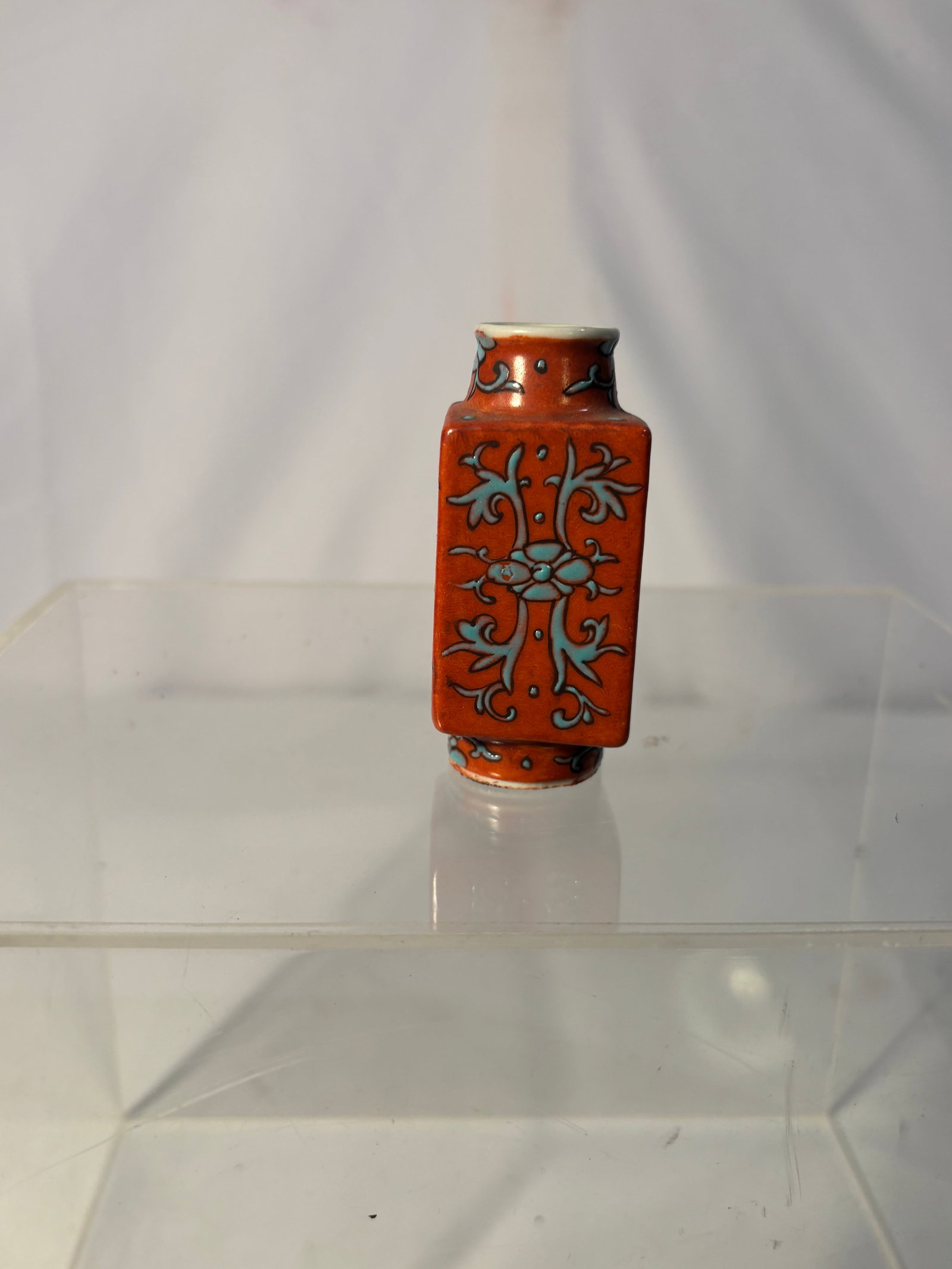 A Chinese Flambe Glazed Miniature Vase with Relief Decoration, Marked “China: Qing Dynasty(1644-1912) ; A small Chinese porcelain vase featuring a rich flambe red glaze with raised decorative motifs in contrasting green tones. The base is marked “China,”. Height: 4 inch