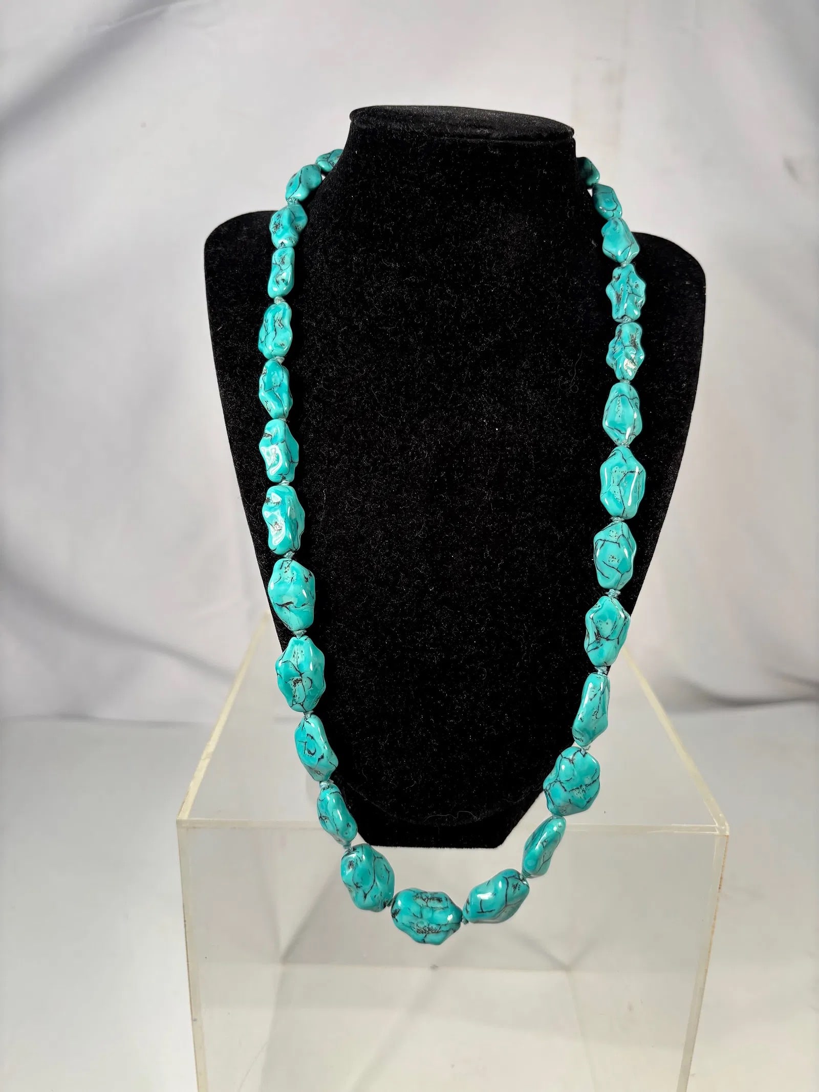 A Vintage Turquoise Nugget Necklace: Necklace composed of elongated turquoise nugget beads displaying natural-style dark matrix patterns. Finished with a barrel clasp. Necklace Length: 25 inches.