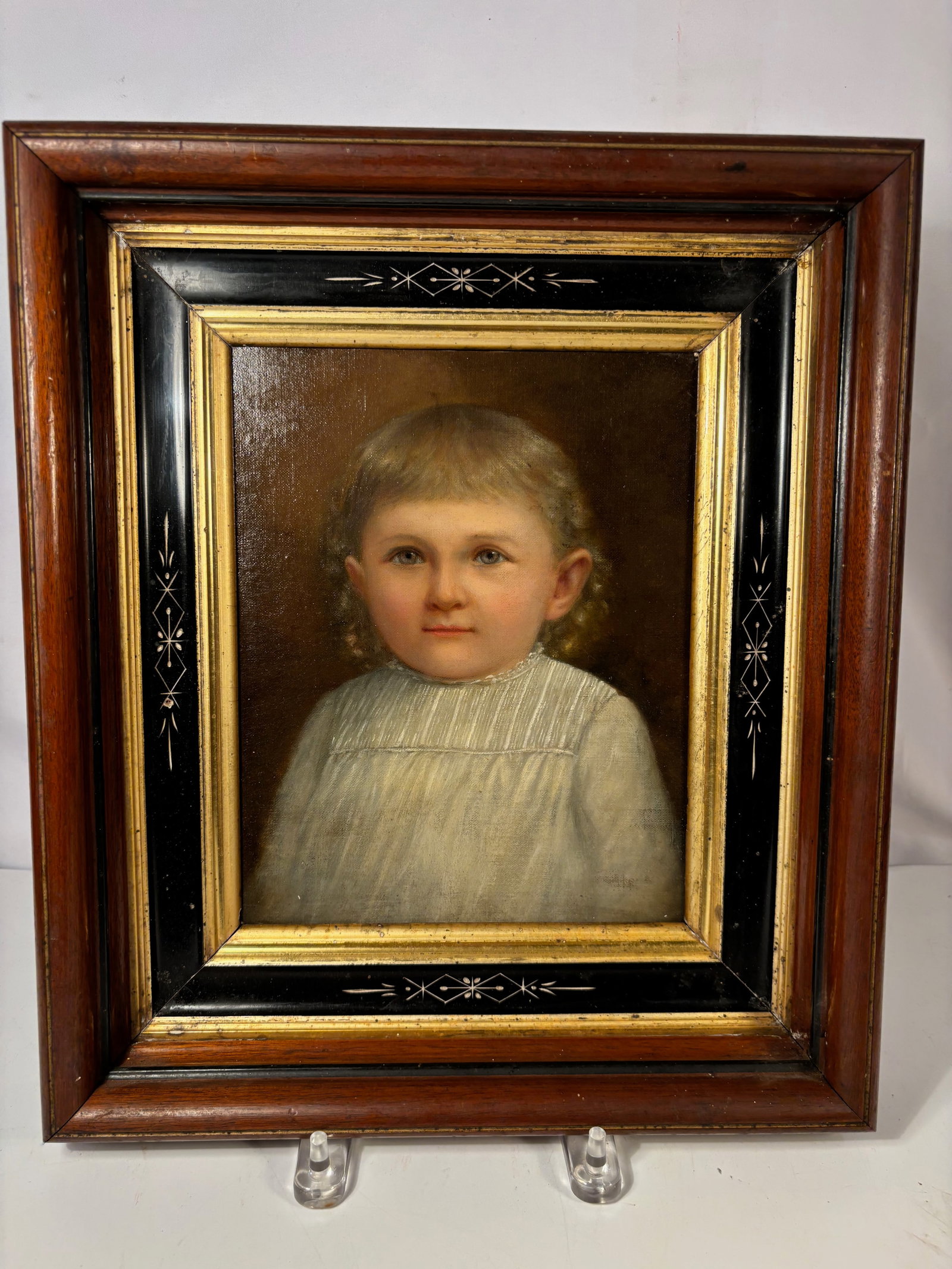 19th Century Portrait of a Young Child, Oil on Canvas: Oil on canvas portrait depicting a young child with light hair and blue eyes, shown wearing a pale dress against a warm brown background. The work displays delicate facial modeling and soft tonal shad