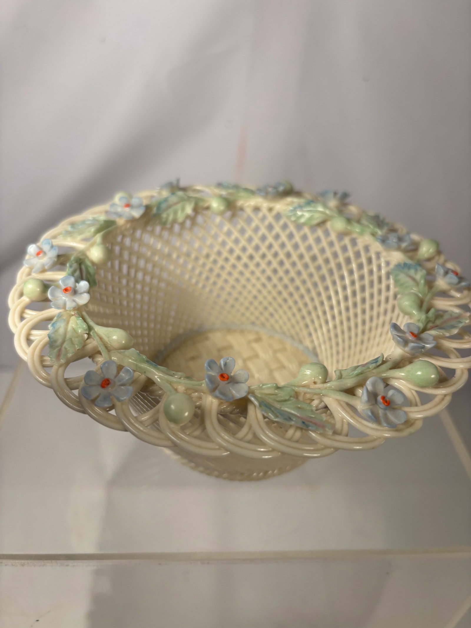 Vintage Belleek Irish Porcelain Basket with Applied Flowers: A finely crafted Belleek porcelain basket from County Fermanagh, Ireland. The cream-colored body is formed from individually modeled porcelain strands in an intricate basketweave and openwork design. 