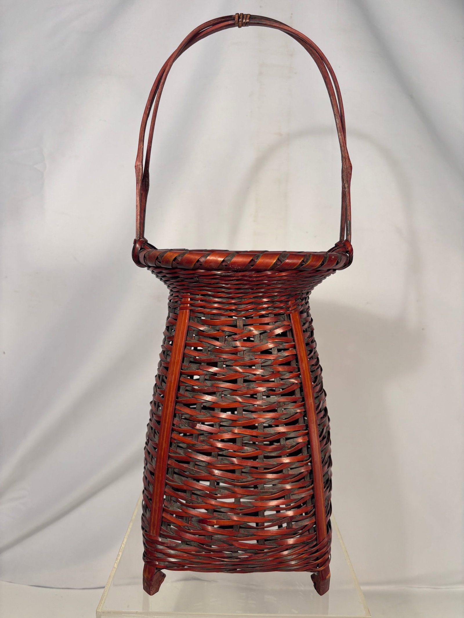 Antique Japanese Meiji Lacquered Bamboo Ikebana Basket: An antique Japanese hanakago flower-arranging basket dating to the Meiji period (1868–1912). The tall tapered body is woven from bamboo in an open, irregular pattern and strengthened by vertical rib