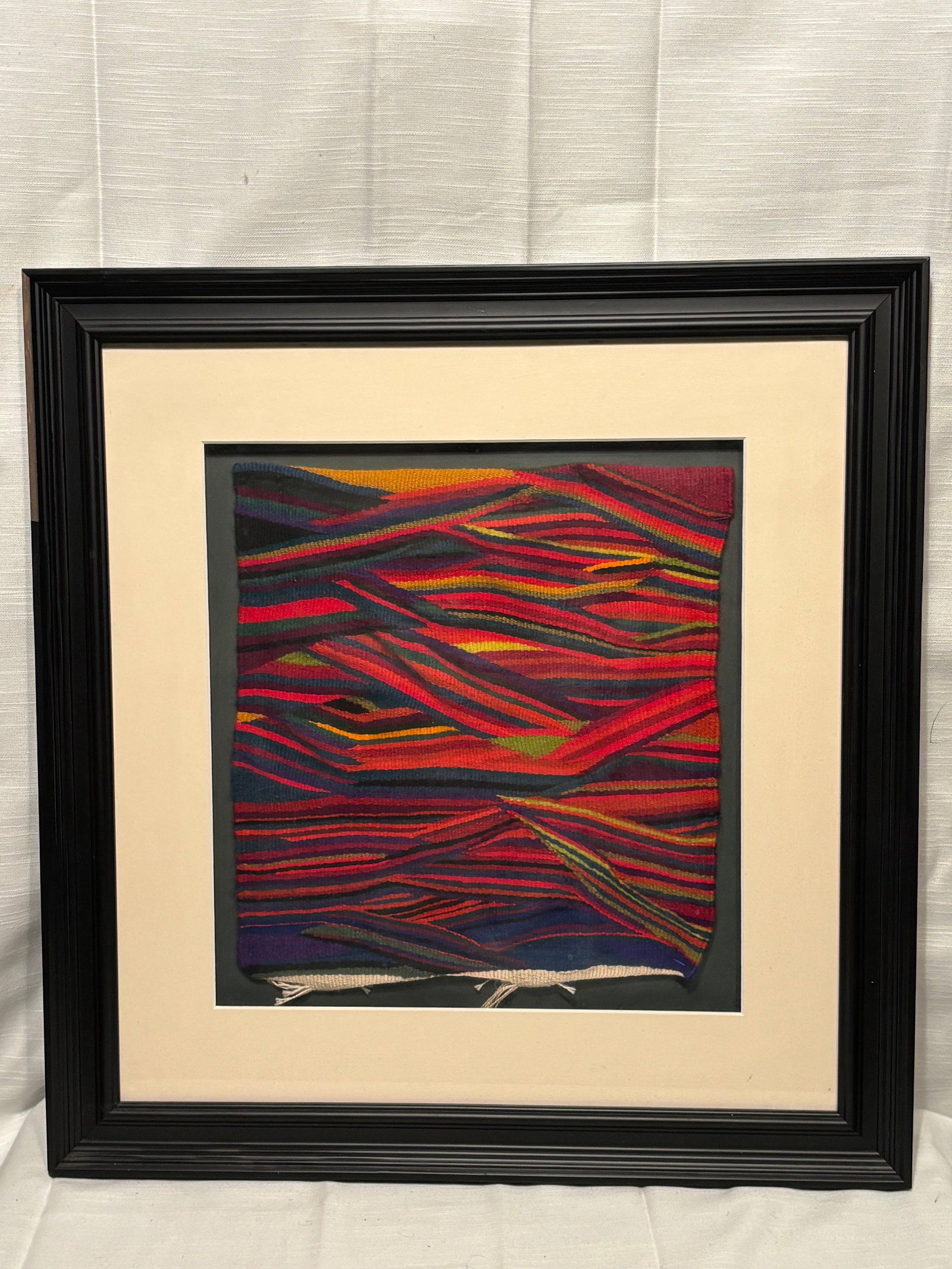 Contemporary Abstract Woven Textile Tapestry, “Eccentric Weave,?? Signed “Liala Kuchna?? (as: A contemporary handwoven textile tapestry featuring an abstract composition of layered, multi-colored linear forms in bold tones of red, orange, green, and dark hues. The dynamic arrangement creates a