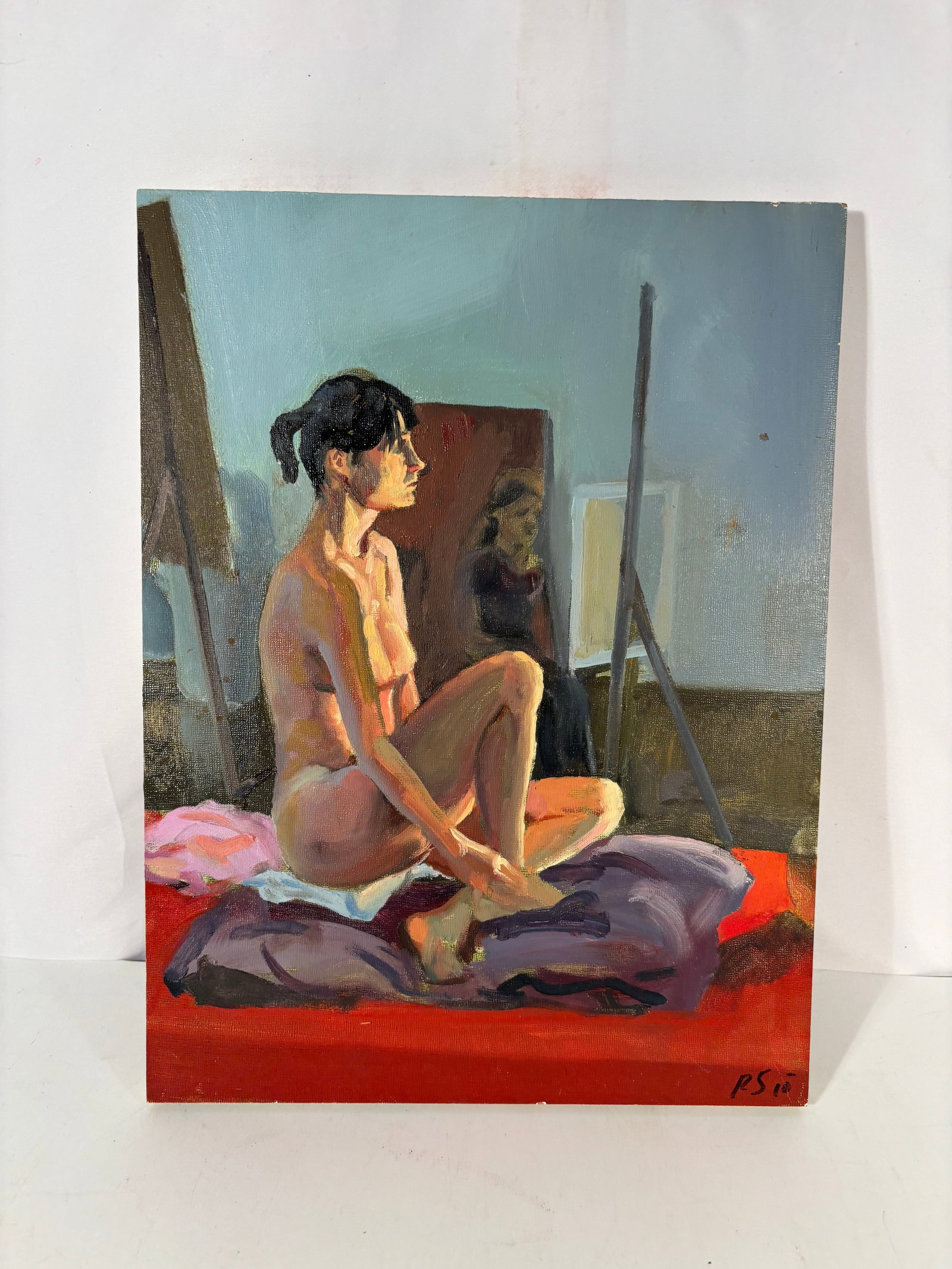 Robert Samartino (American, contemporary) Seated Nude in Studio, 2010: Oil on canvas depicting a seated female nude model in profile, posed on layered violet and white cushions against a vivid red foreground. The composition shows strong studio light effects, expressive