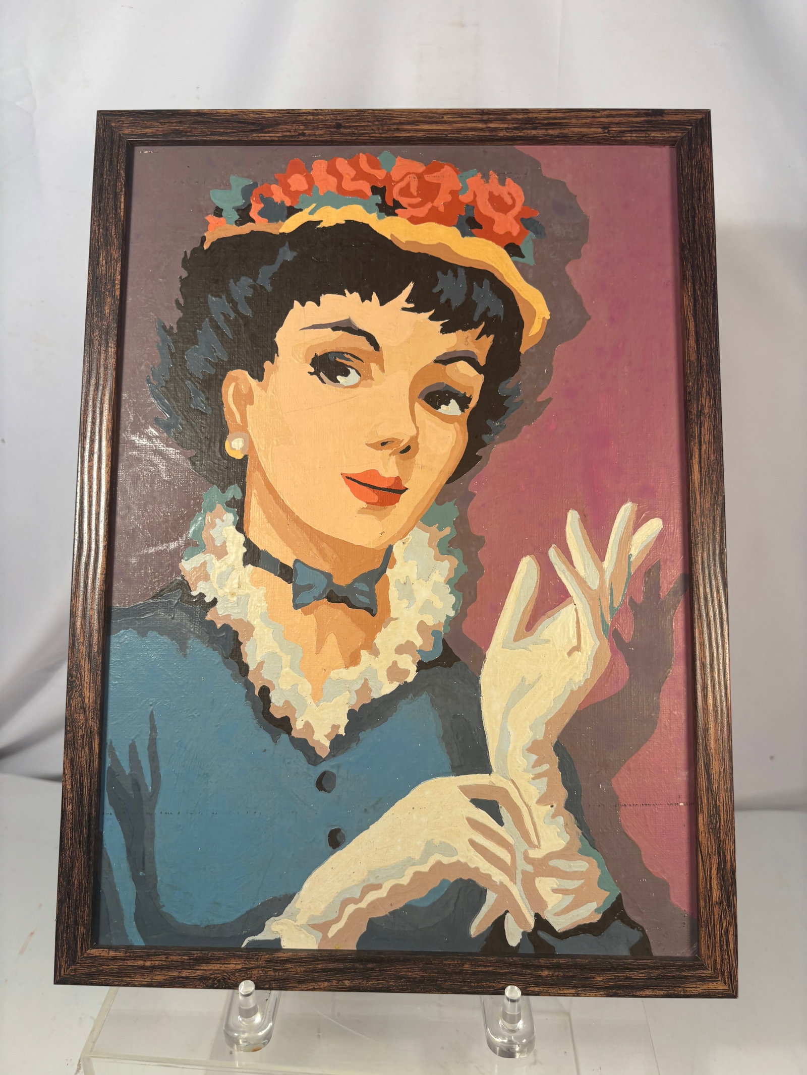 Vintage Mid-Century Paint-by-Numbers Portrait of an Elegant Woman: A vintage mid-century paint-by-numbers portrait depicting an elegant woman wearing a floral hat, pearl earrings, blue dress, and white gloves. Rendered in bold stylized colors and presented in its ori