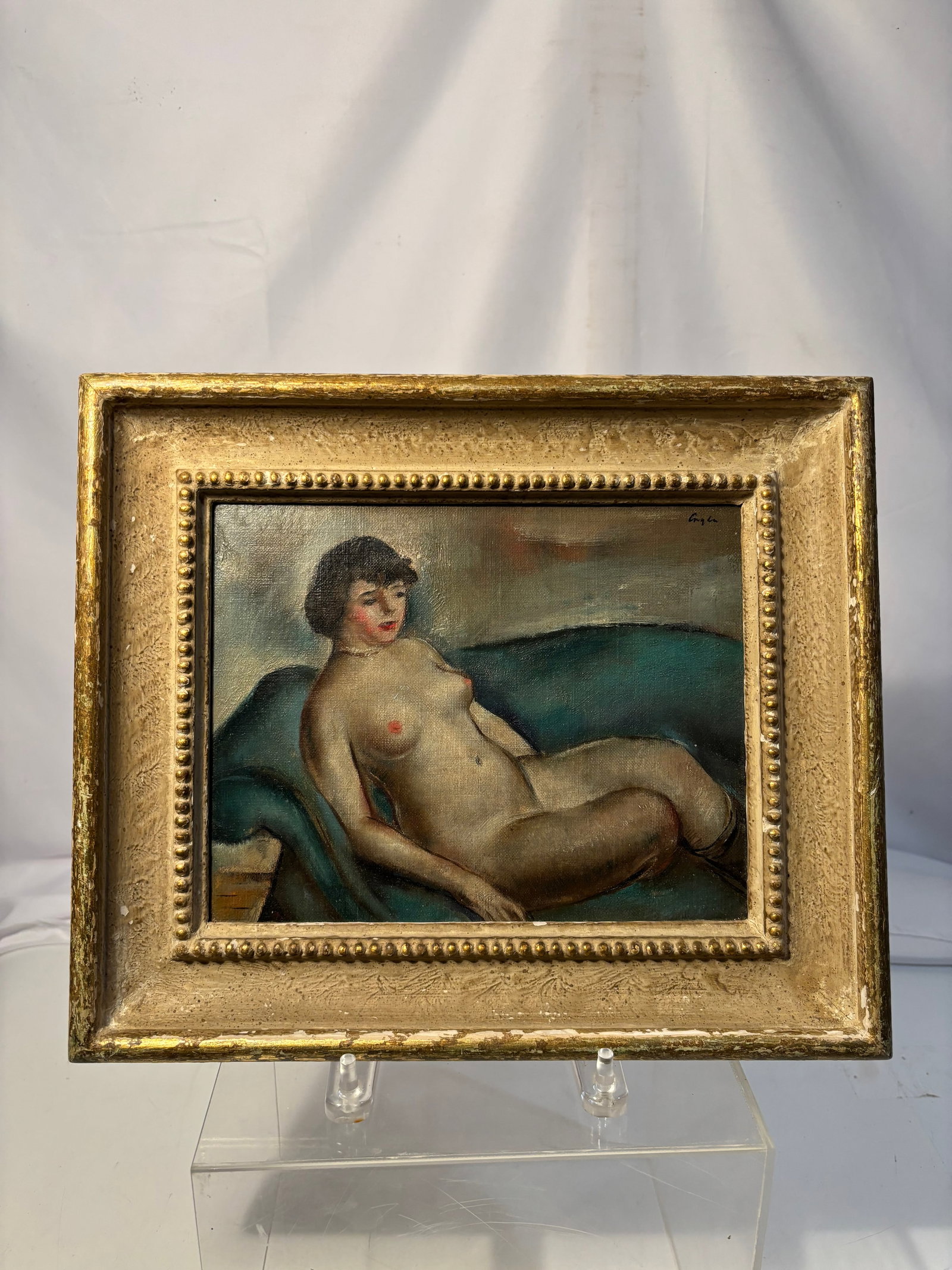 Charles Cagle (American, 1907–1968) Reclining Nude Oil Painting: Small oil on board depicting a reclining female nude figure against a teal draped ground. Signed upper right, apparently “Cagle.” Housed in a gilt frame. Executed in an expressive modernist