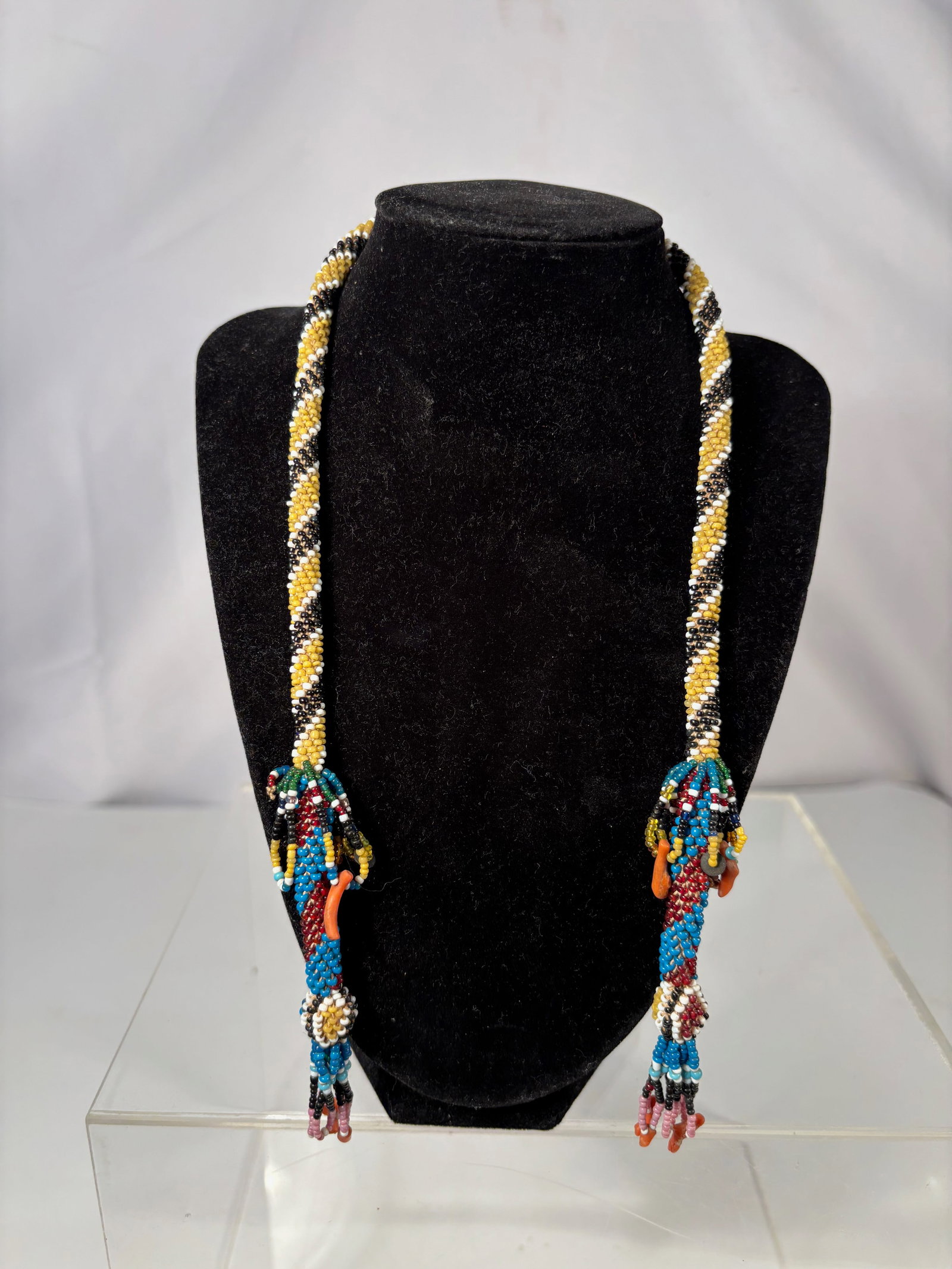 A Native American Plains Beaded Necklace with Coral, Tubular Peyote Stitch, c. 1900: Native American beaded necklace, likely Plains or Great Lakes region, dating to the late 19th or early 20th century. The necklace is constructed with a tubular peyote-stitched neck ring in yellow, whi