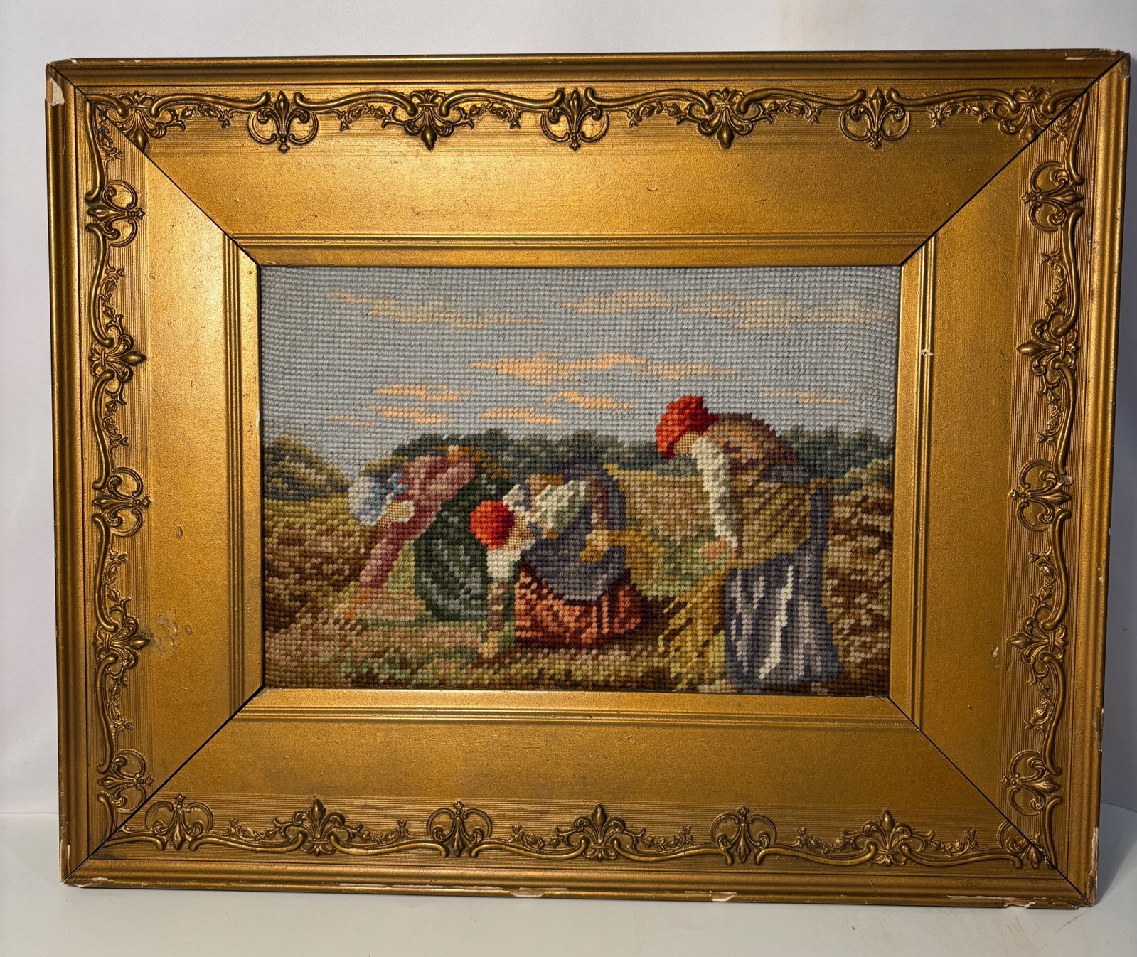 A Continental European Pictorial Tapestry or Needlework Wall Hanging, 19th Century: Continental European pictorial tapestry or needlework wall hanging, 19th century, depicting a rural genre scene of women gathering along a shoreline with geese, boats, and a pastoral landscape in the 