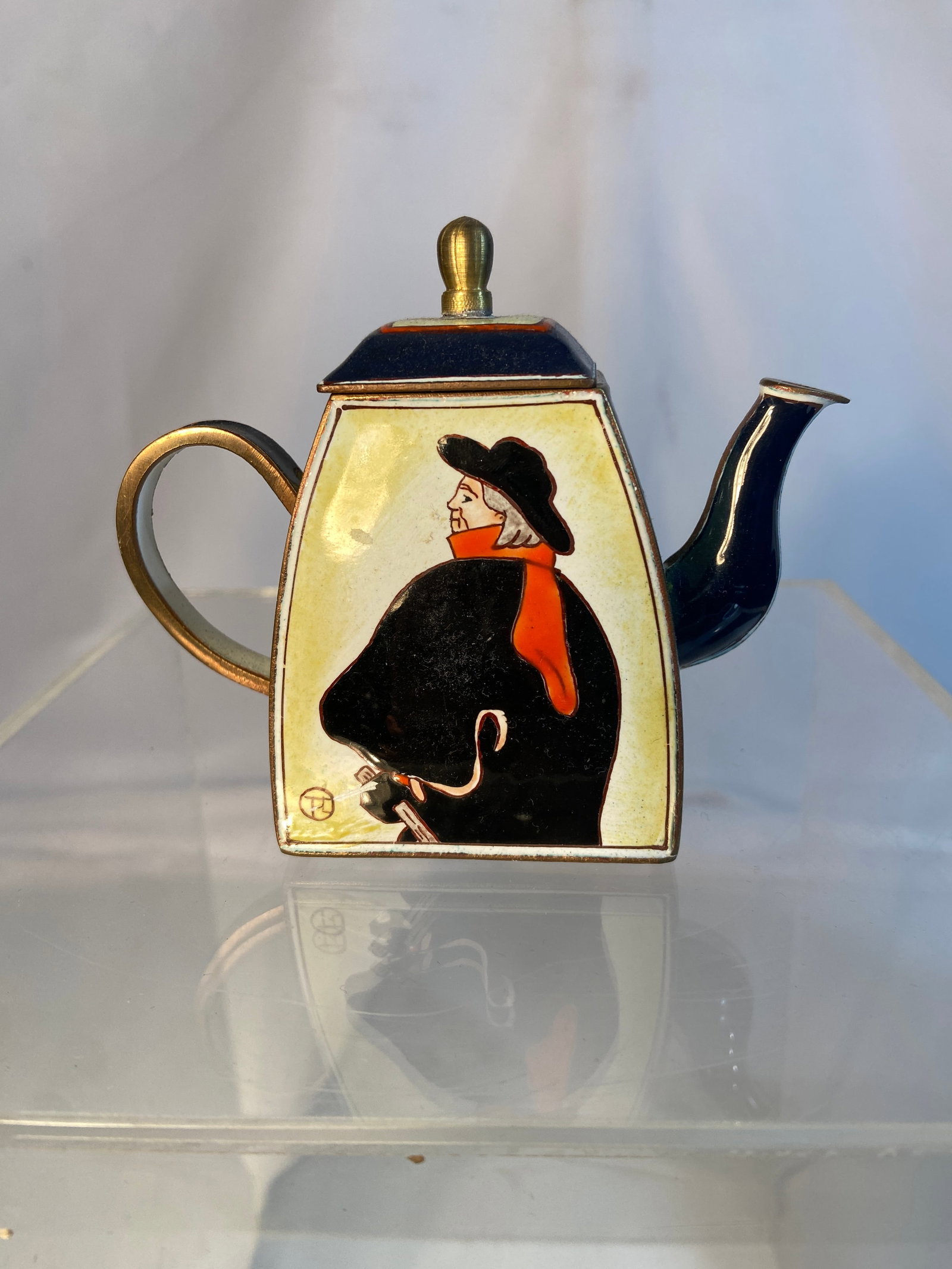 French Art Deco Enameled Brass Miniature Teapot in the Manner of Toulouse-Lautrec: French Art Deco brass and enamel miniature teapot, executed in the manner of Henri Toulouse-Lautrec. The geometric form decorated with hand-painted enamel panels depicting a stylized Parisian figure i